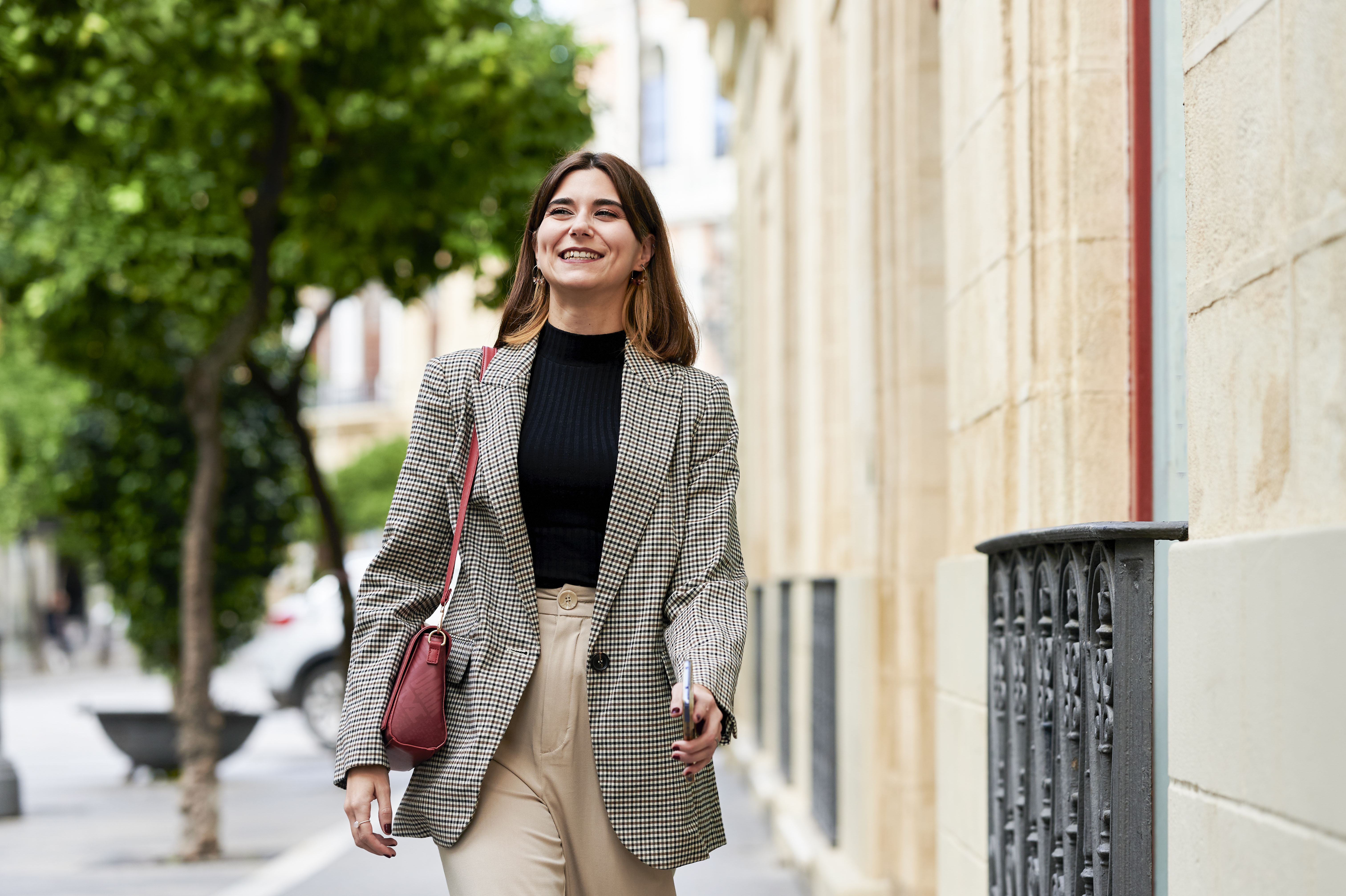 women wearing blazer walking on street