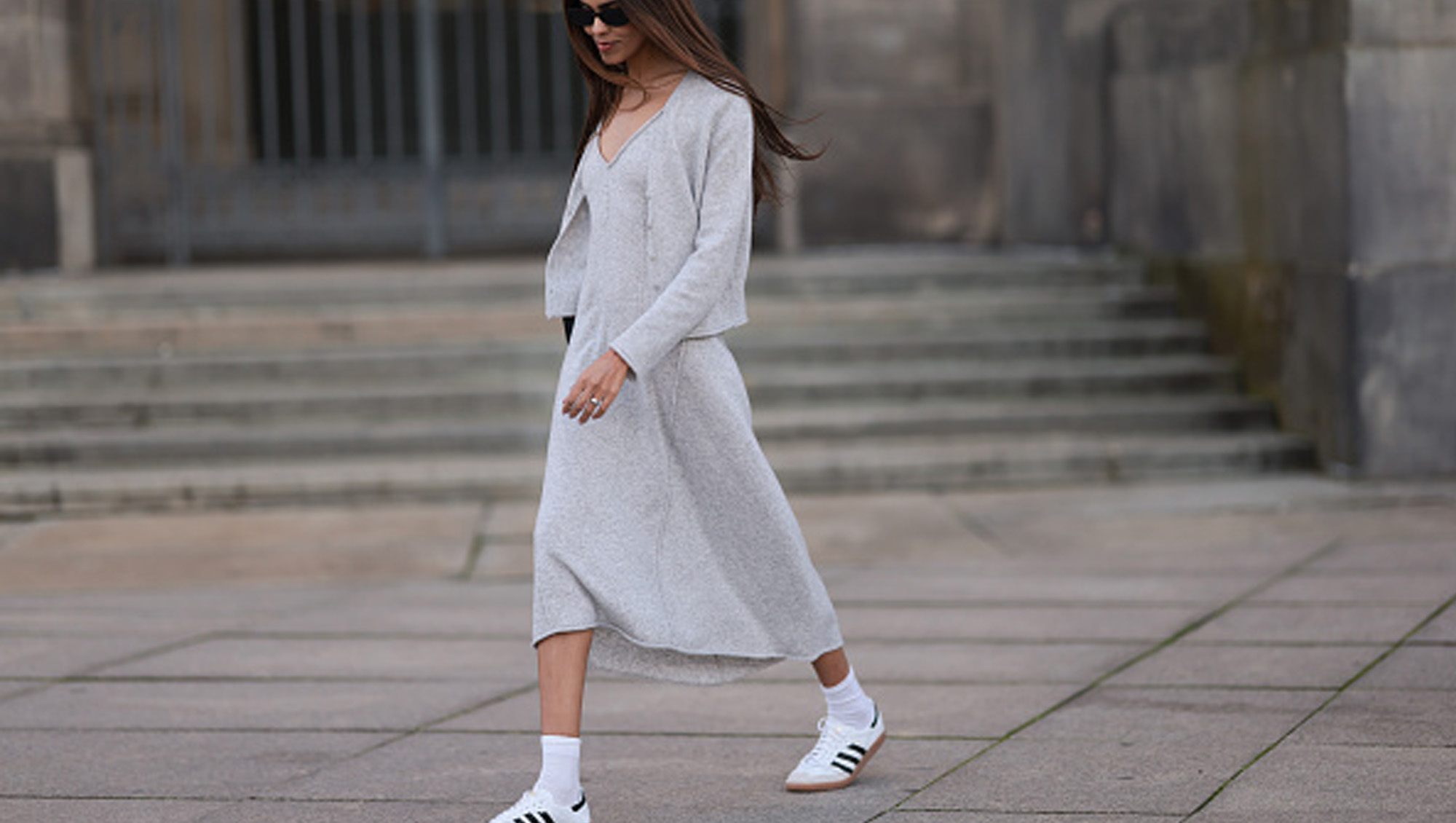 woman wearing gray sweater dress and sneakers