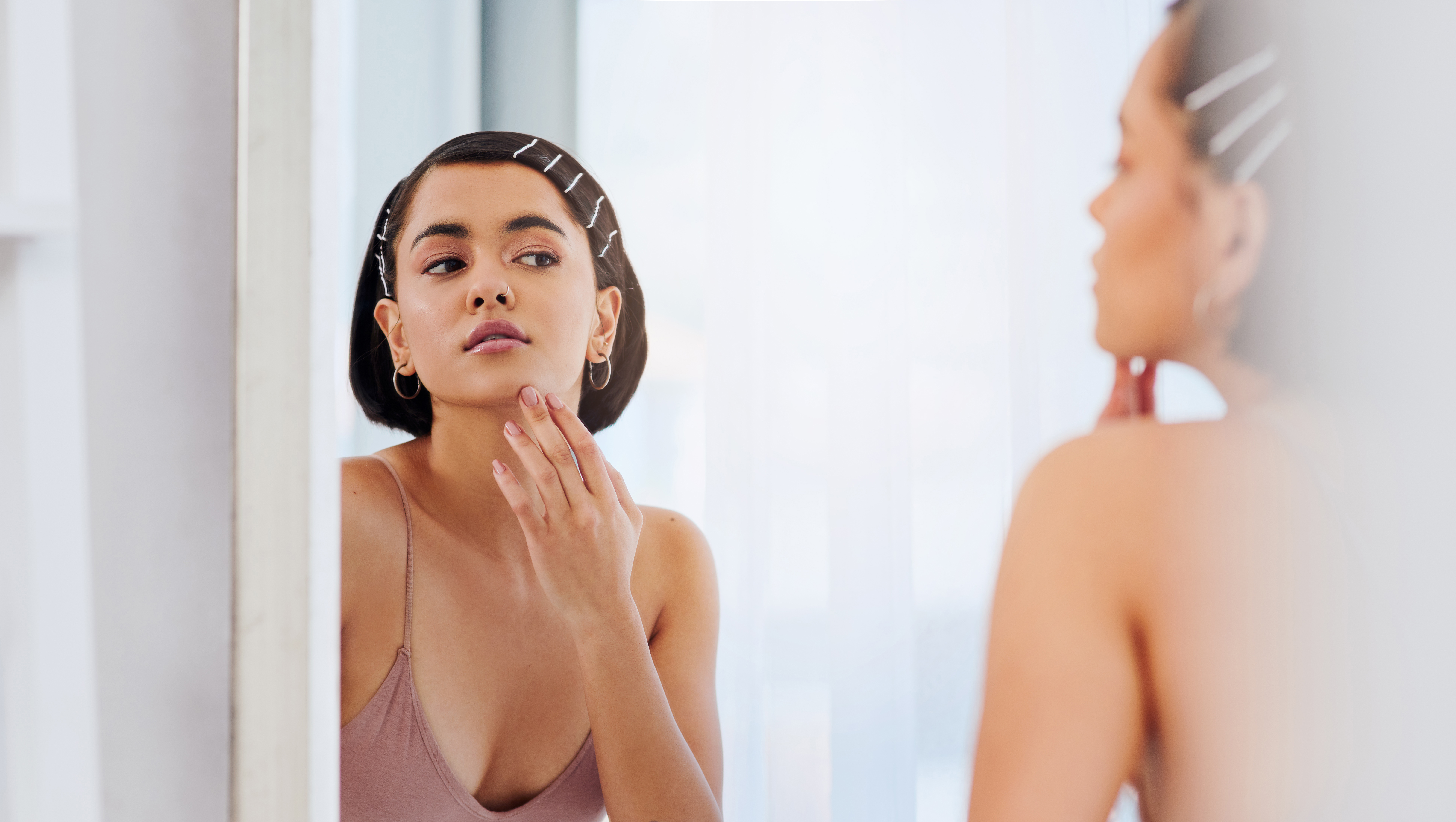 Shot of an attractive young woman going through her morning beauty routine at home