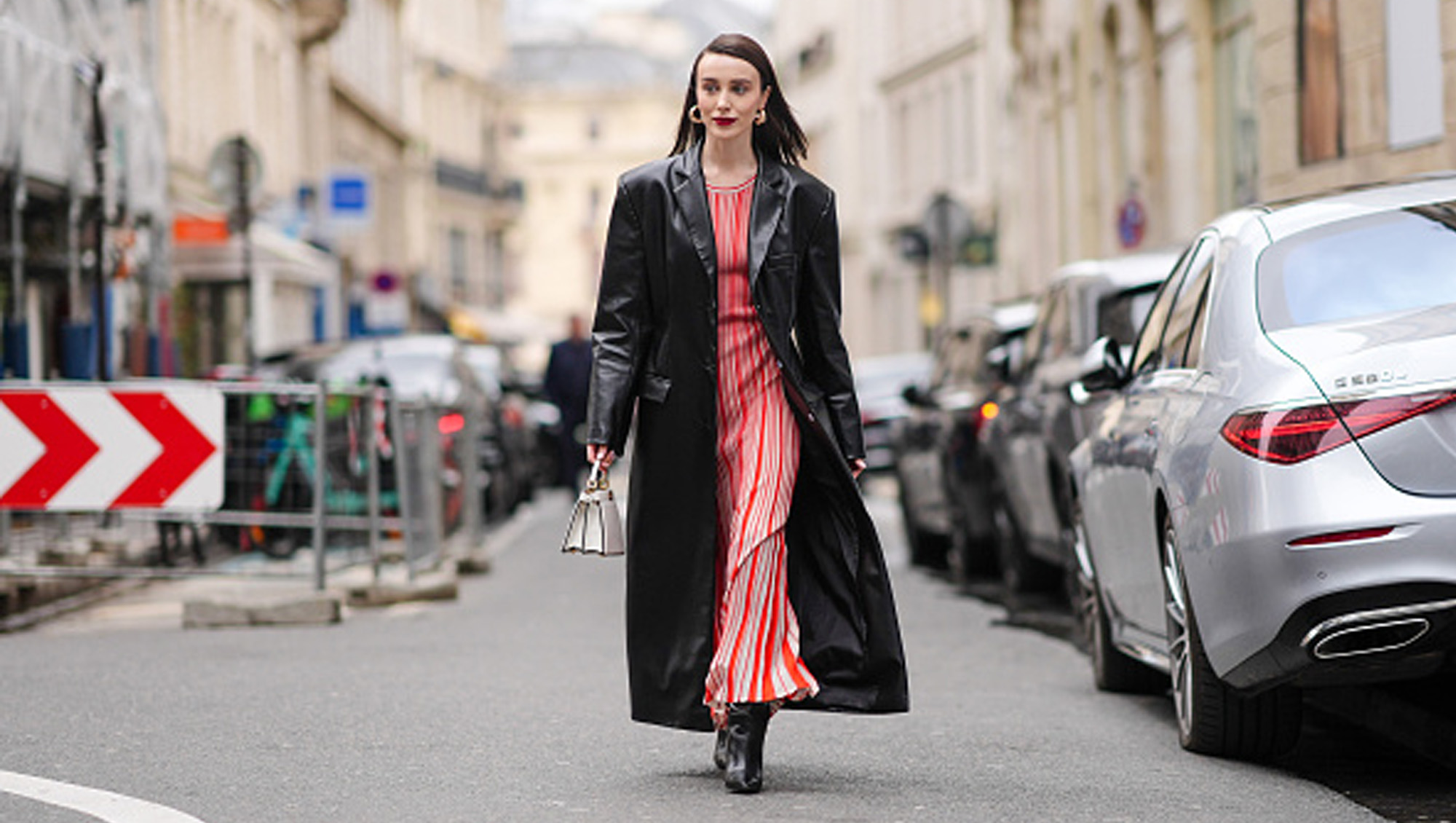 woman wearing red dress and black coat