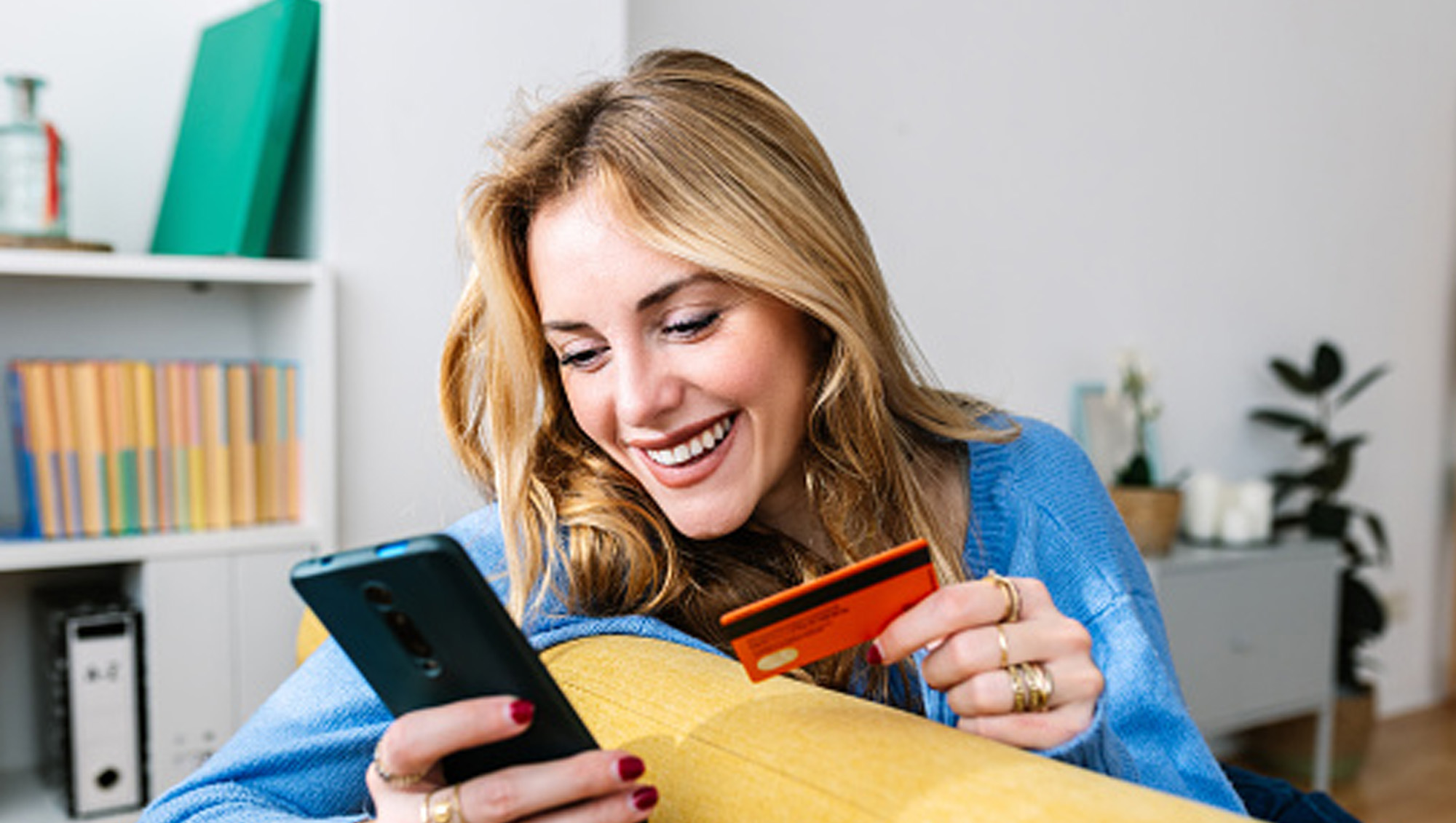woman online shopping with credit card and phone