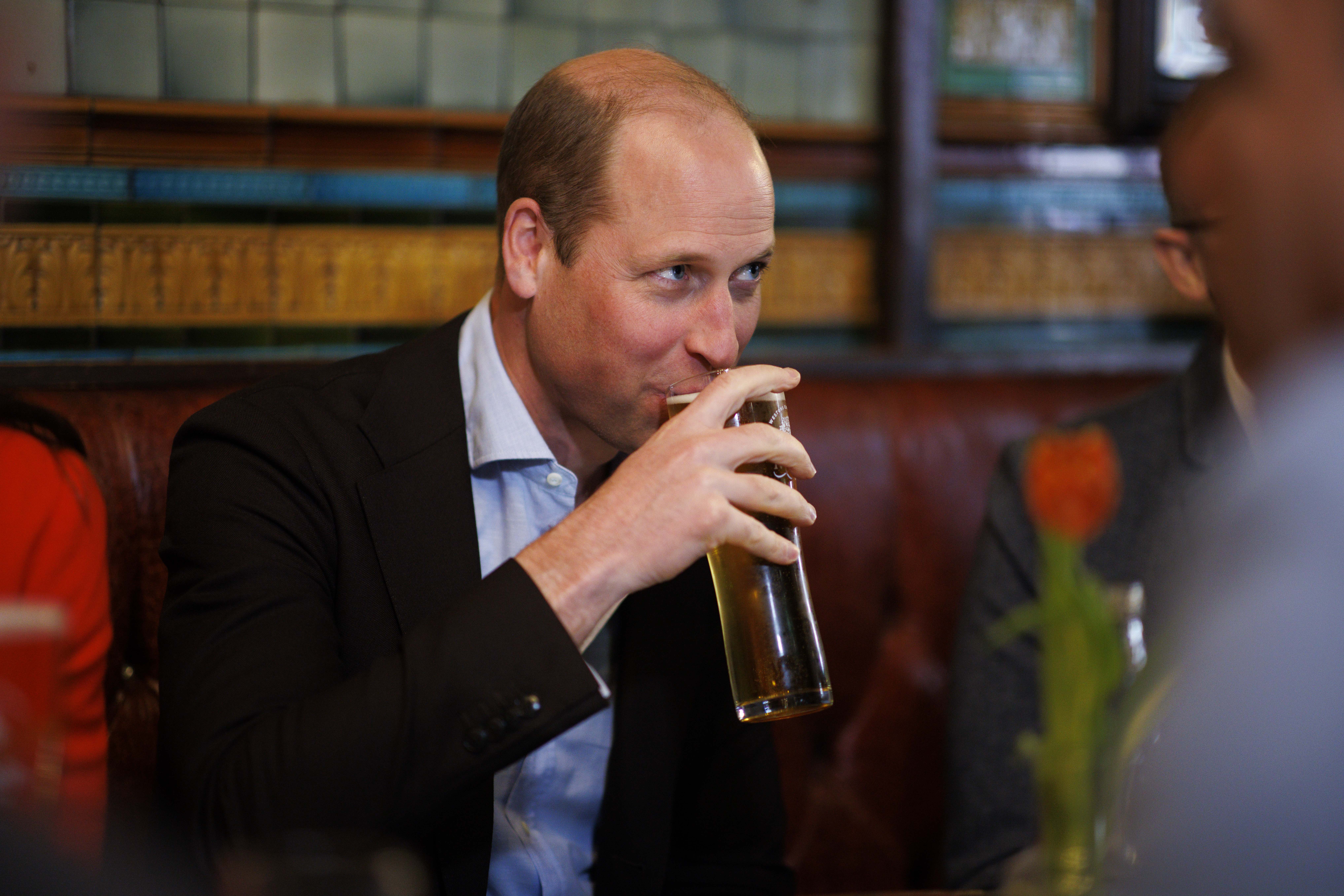 Prince William sips a pint of cider.