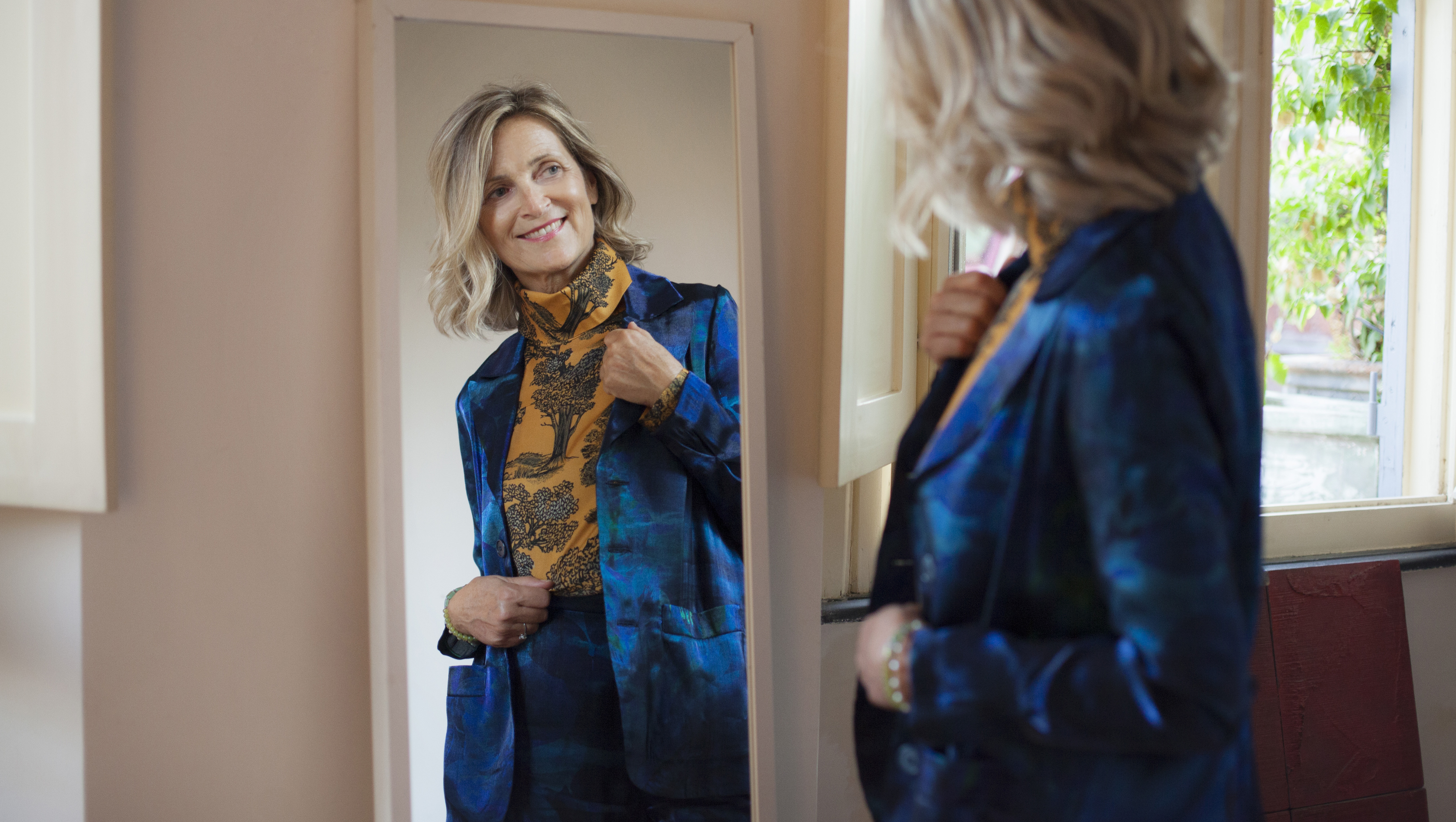 Beautiful mature woman checking herself in the mirror