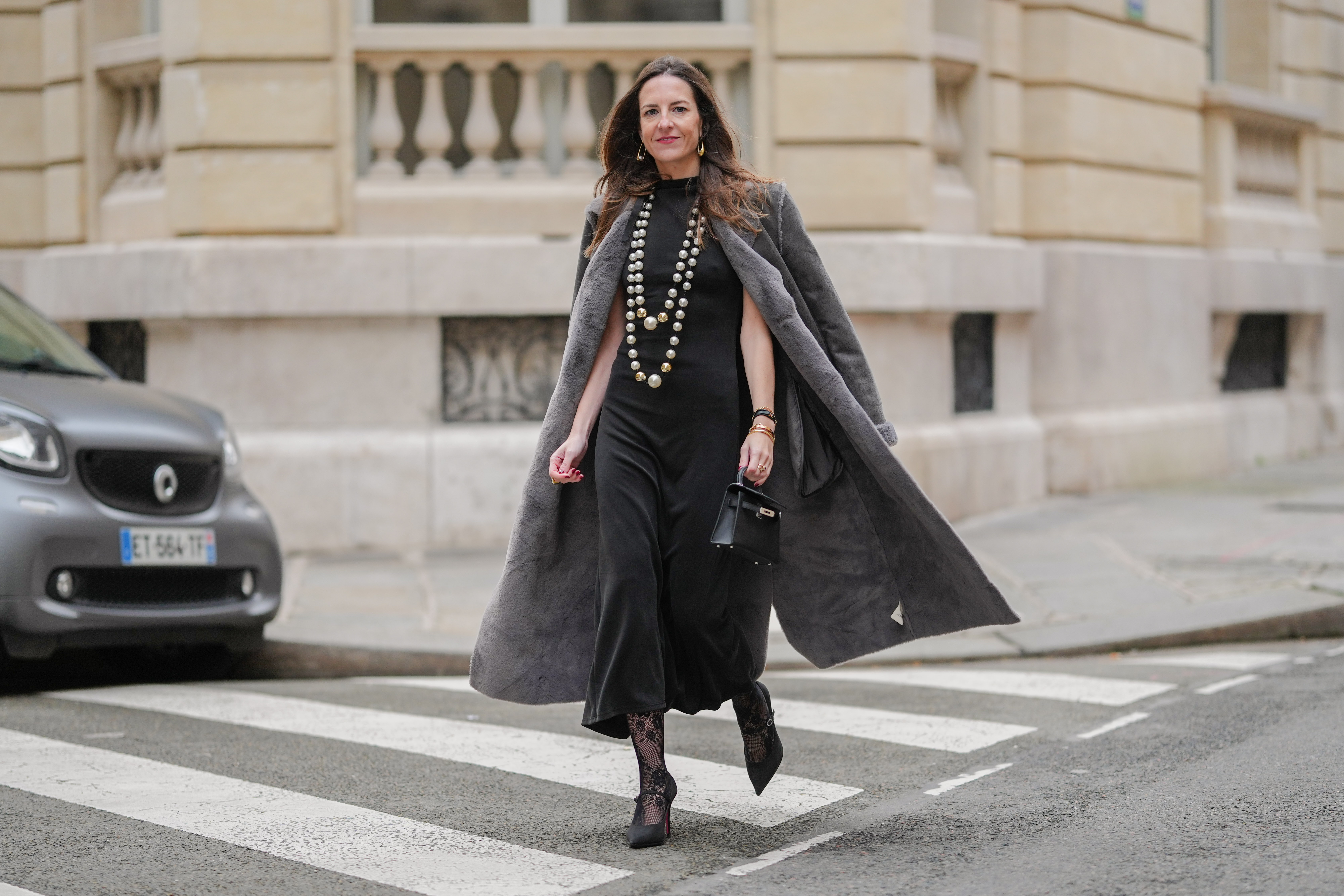 woman wearing black dress and gray coat