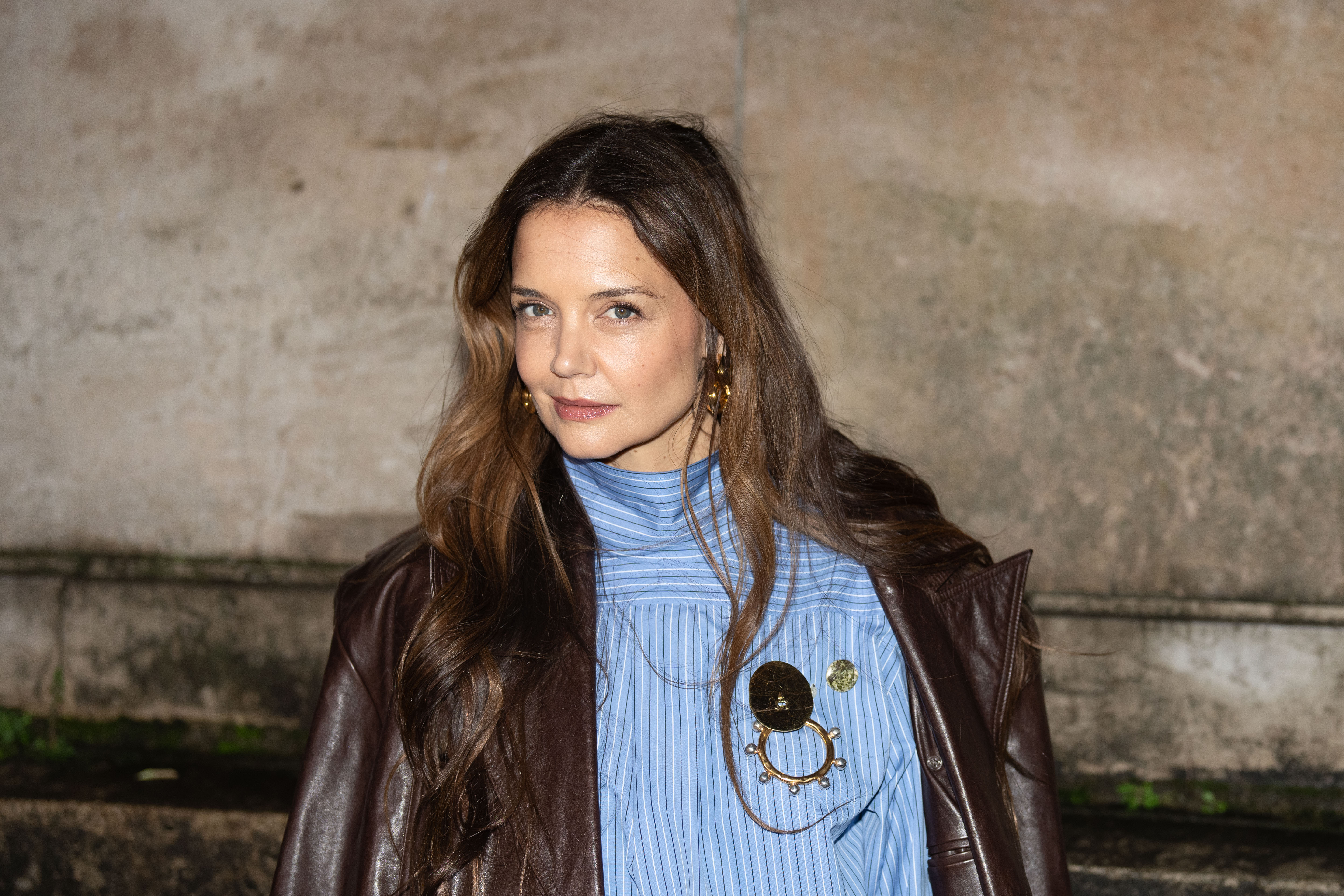 katie holmes in blue top and brown coat