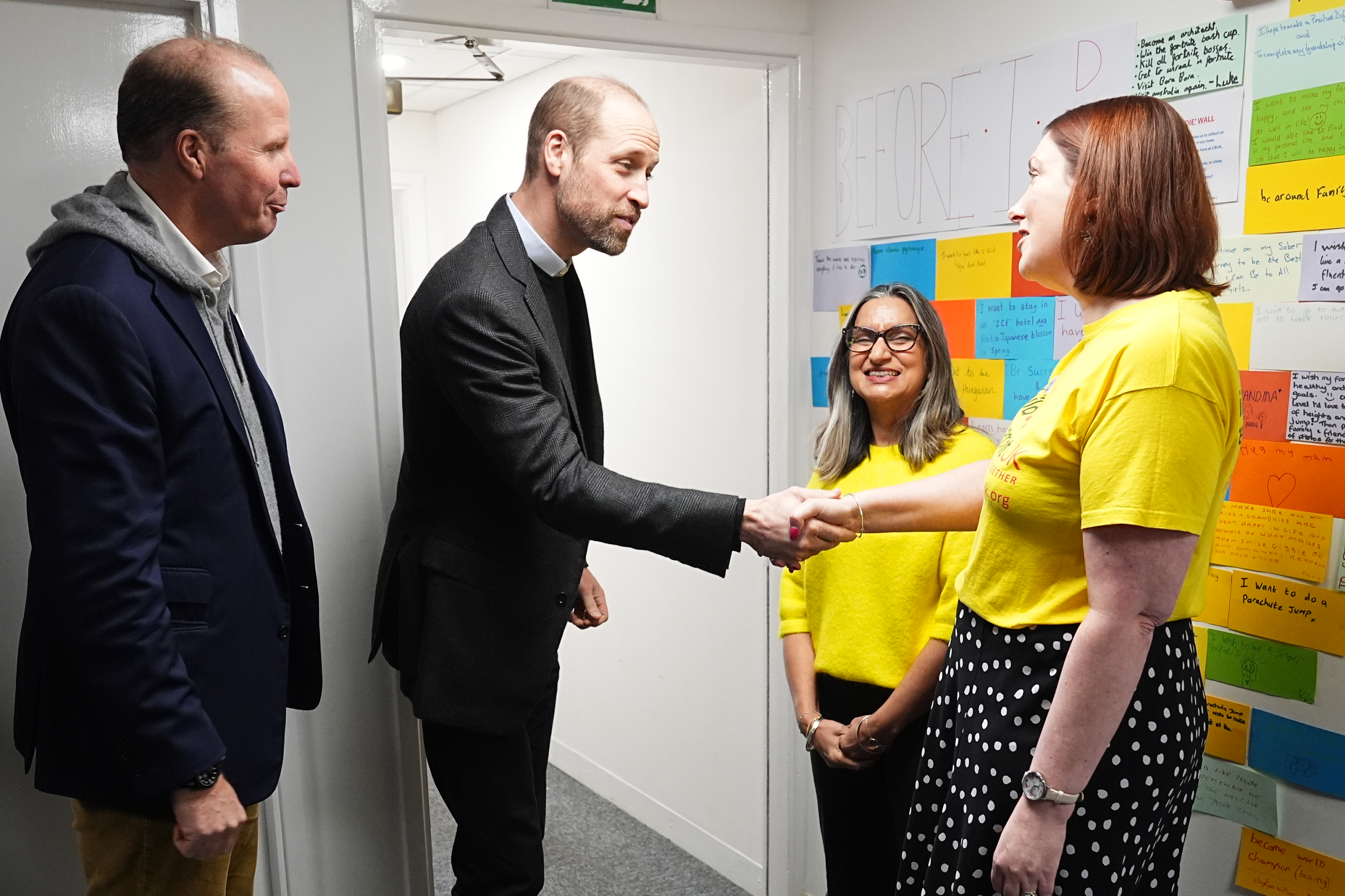 Prince William shakes a woman's hand