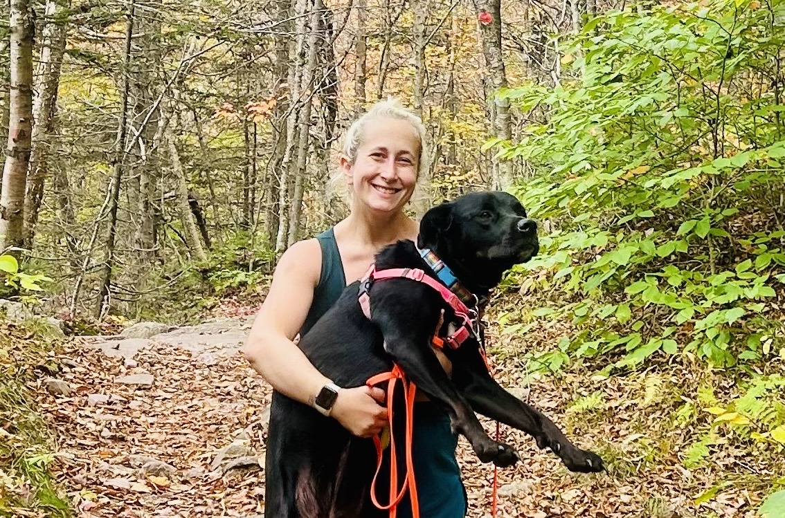 Lizzy Rosenberg and her rescue dog, Cricket on a hike