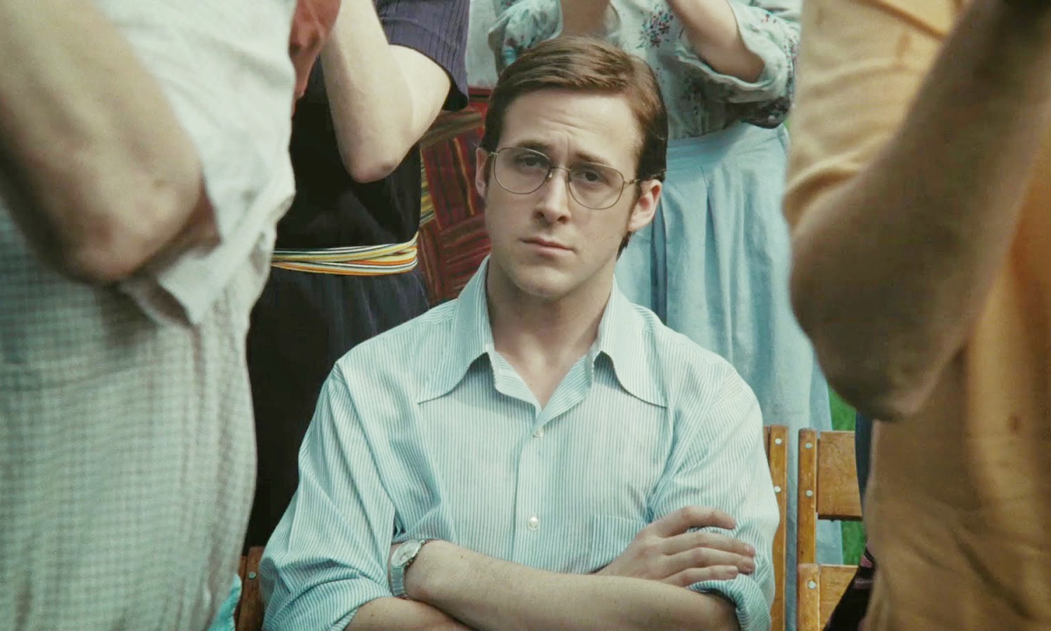 Ryan Gosling sits with his arms crossed in All Good Things.