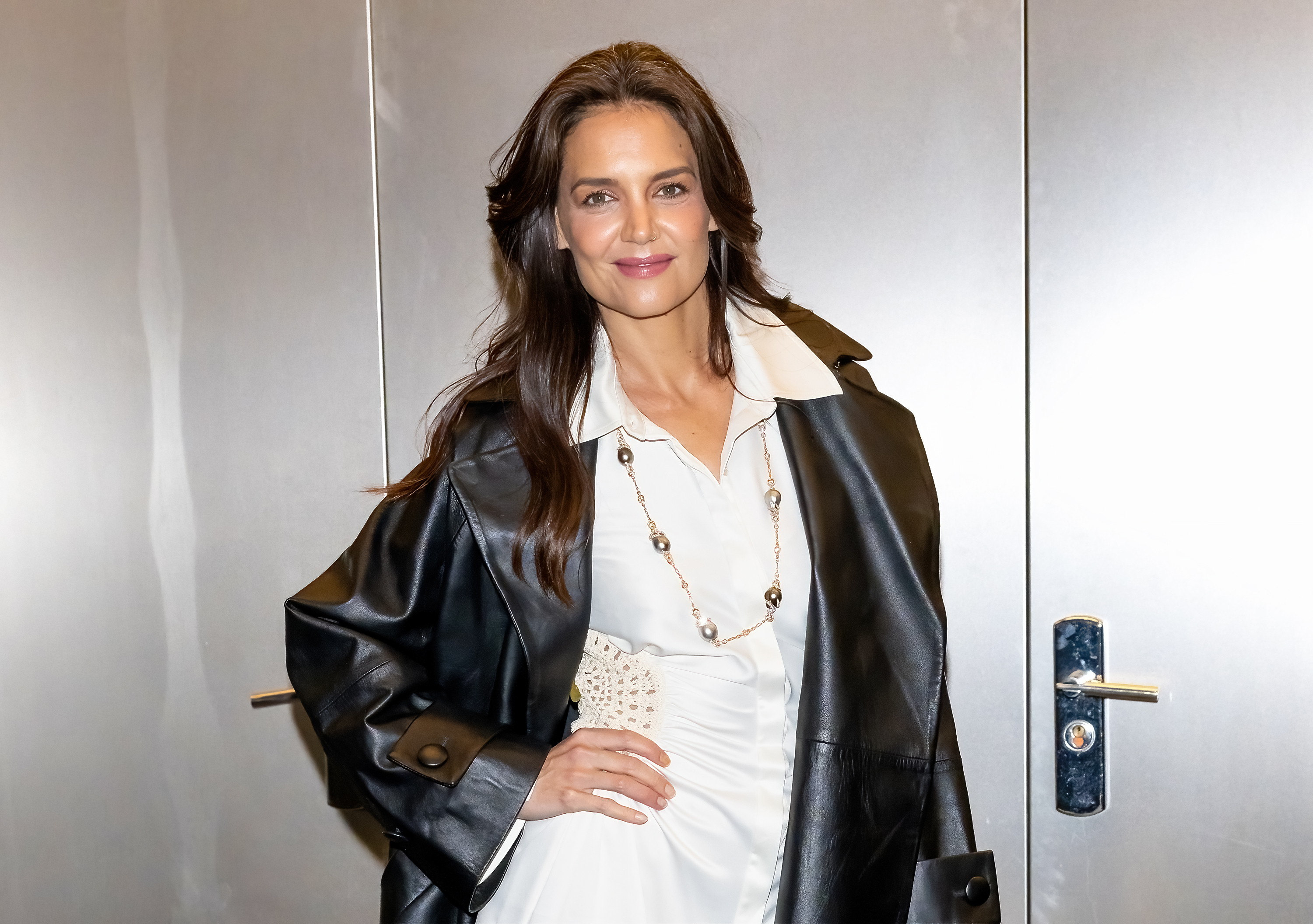 Katie Holmes in black coat and white top