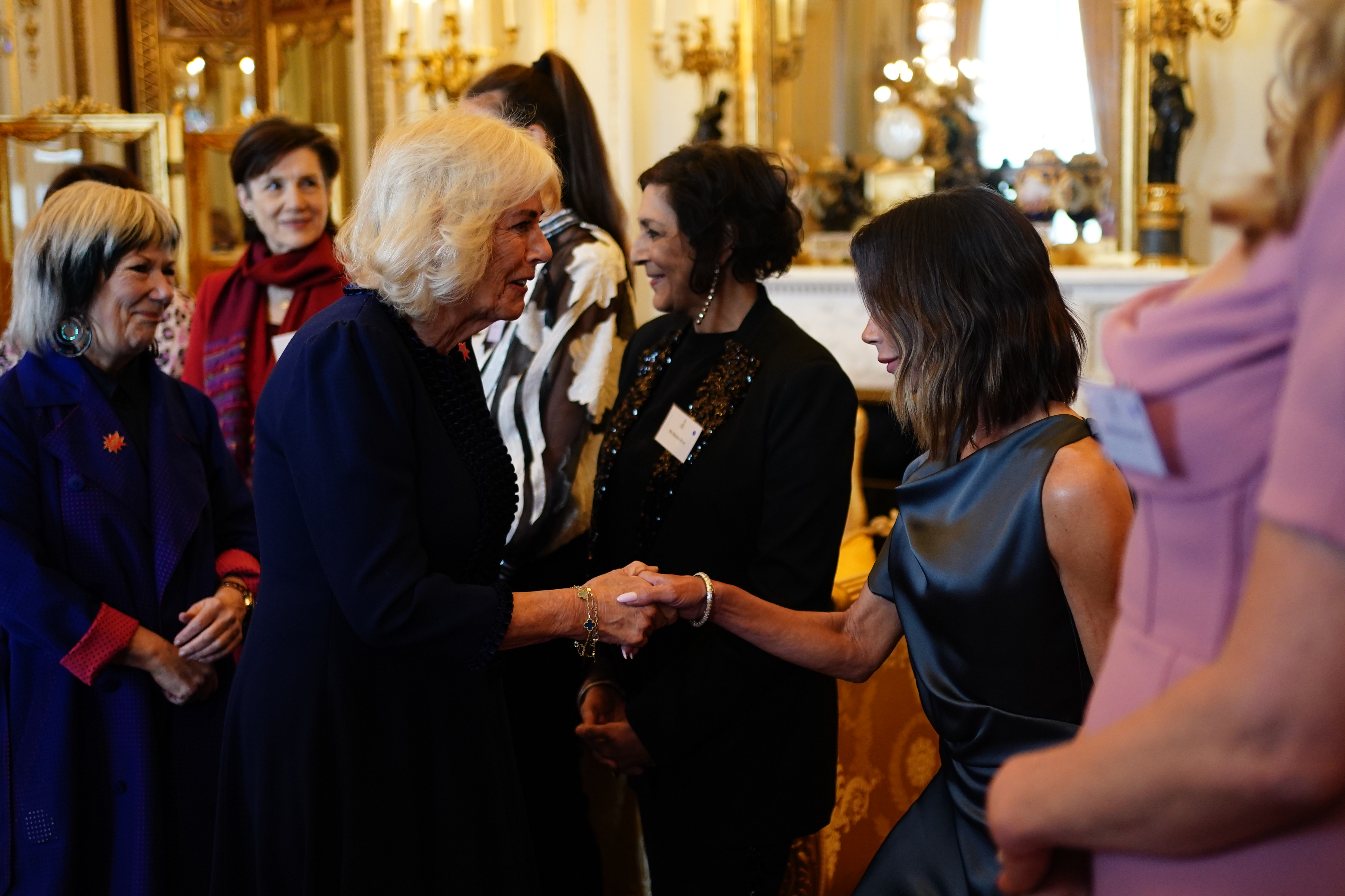 Victoria Beckham curtsies to Queen Camilla