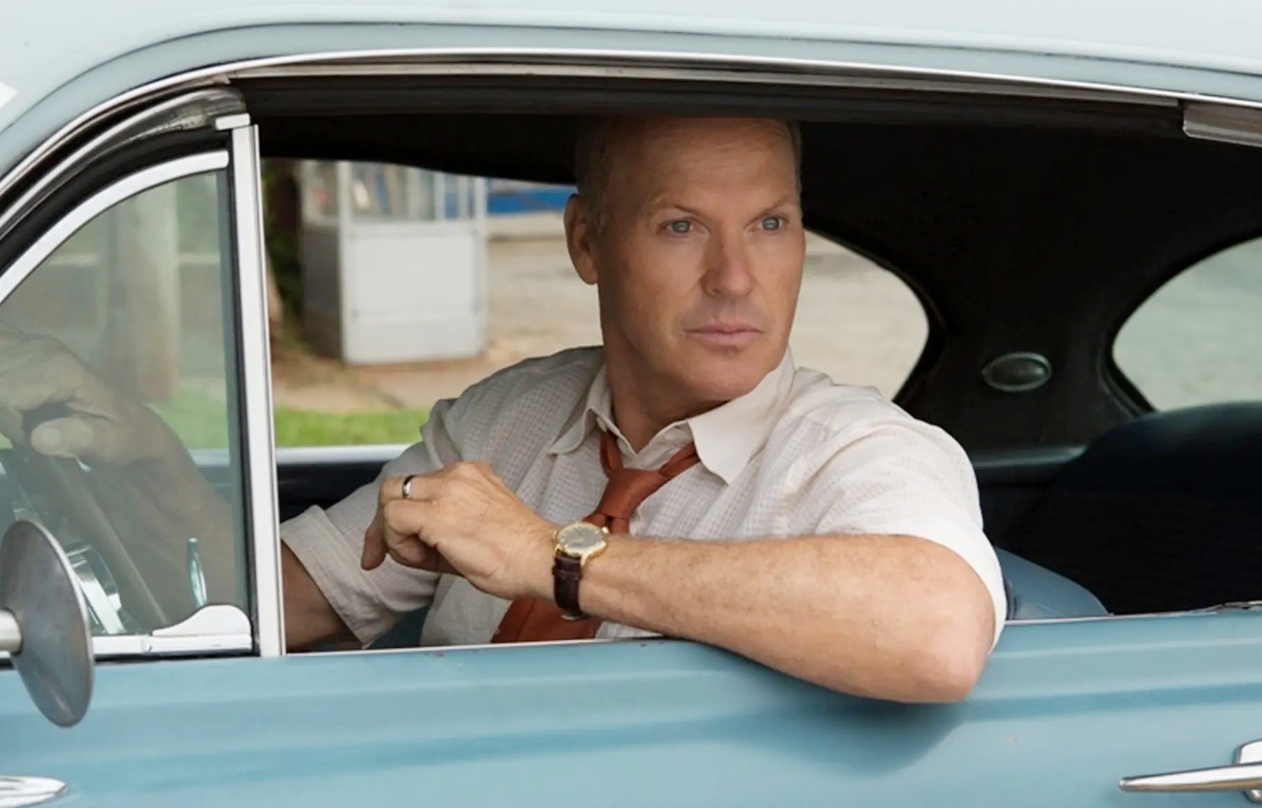 A man leans out of a car in The Founder.
