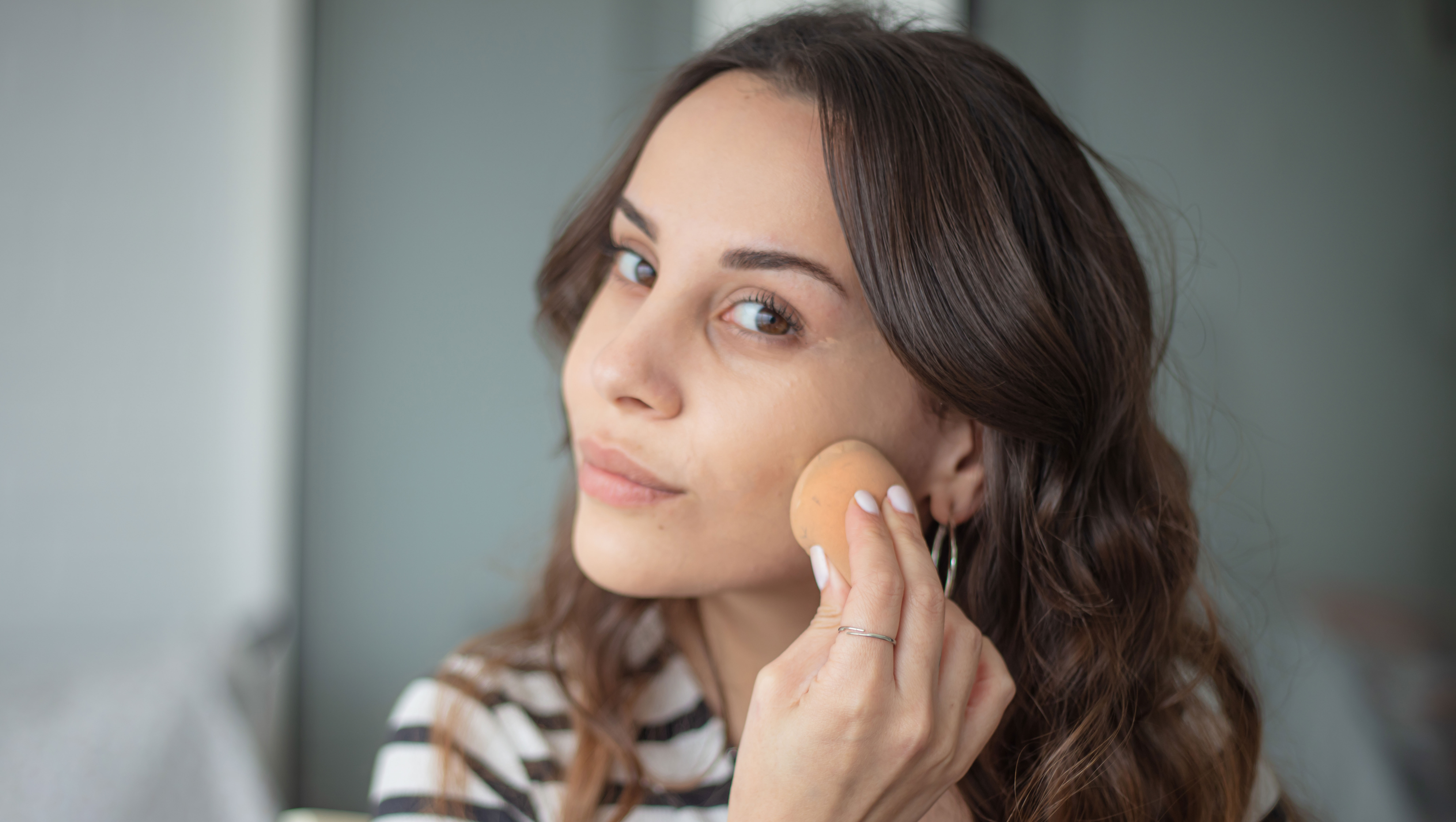 Young woman is doing a make-up. - stock photo