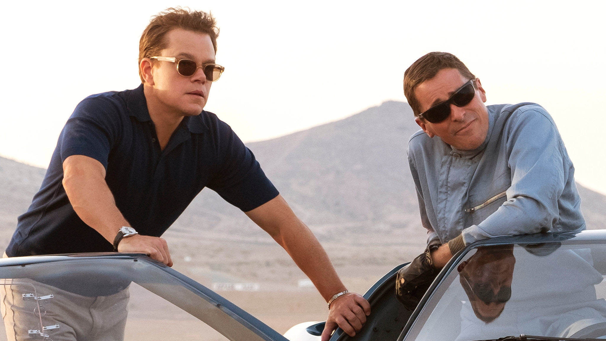 Matt Damon and Christian Bale look at the race track in Ford v Ferrari.
