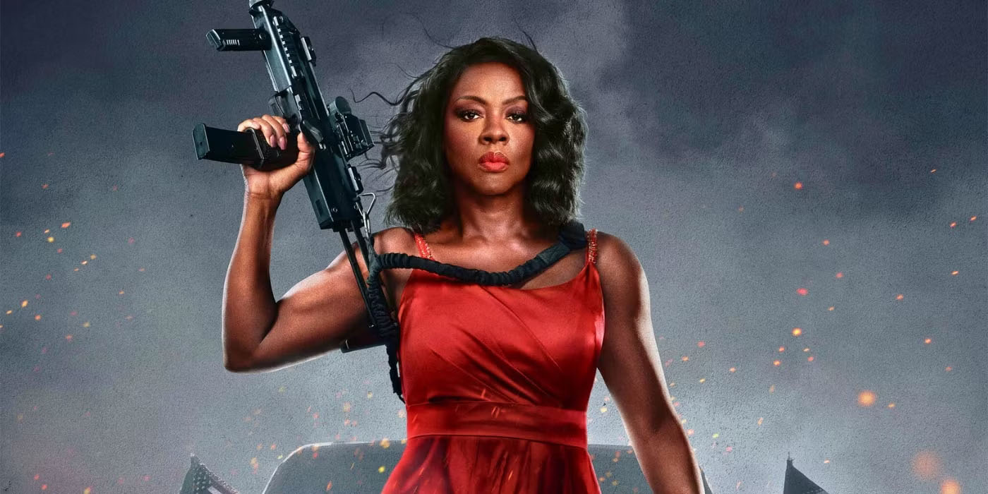 Viola Davis holds a gun while wearing a red dress in G20.