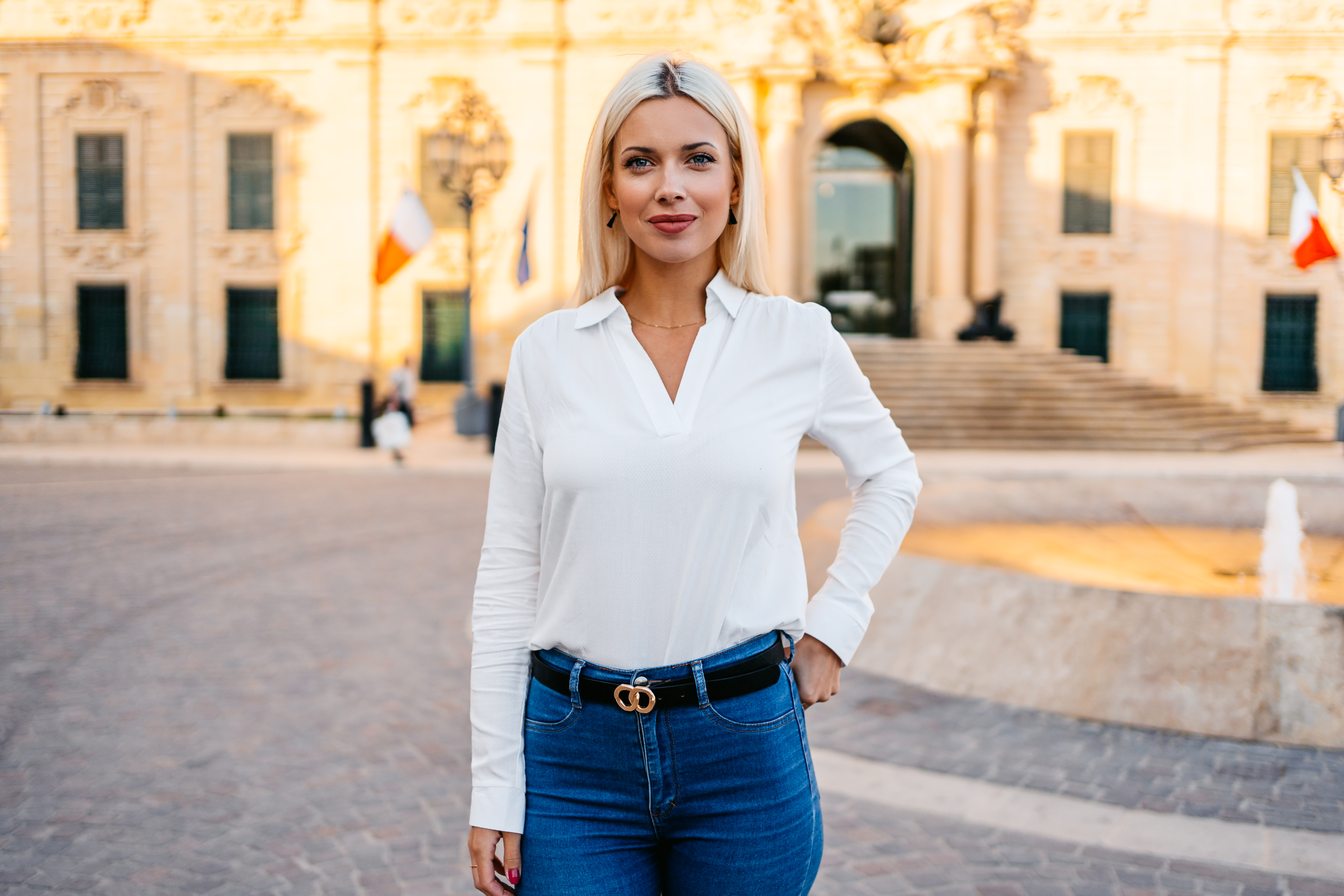 Portrait of a beautiful young blonde woman on the town square in Valletta, Malta.
