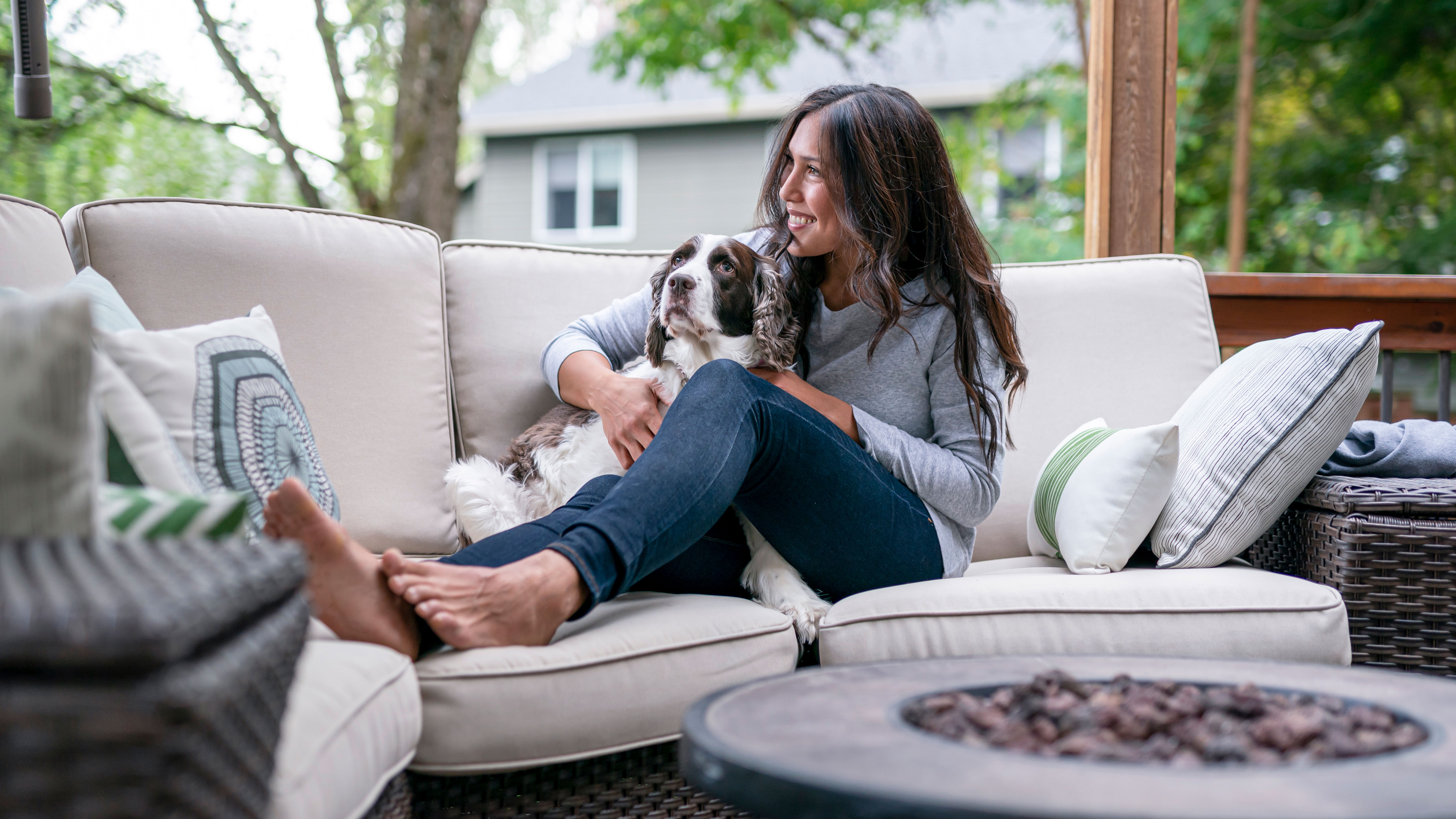 Beautiful Eurasian Woman Spending Time With Her Dog Outside - stock photo