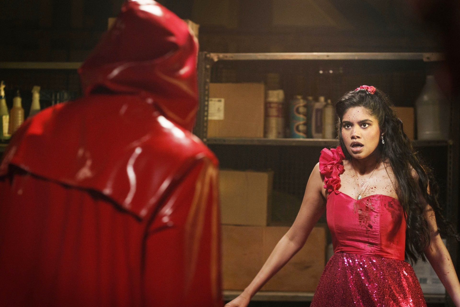 A girl looks at a masked stranger in Fear Street: Prom Queen.