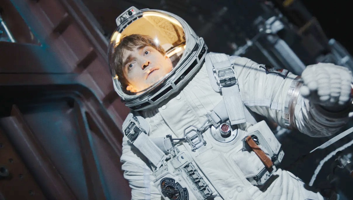 An astronaut floats in space in Mickey 17.