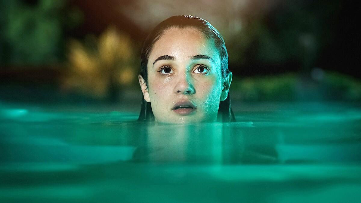 A girl look up in a pool in 'Bad Influence.'