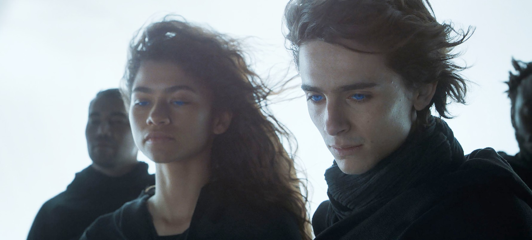 A man and a woman look down in 'Dune.'