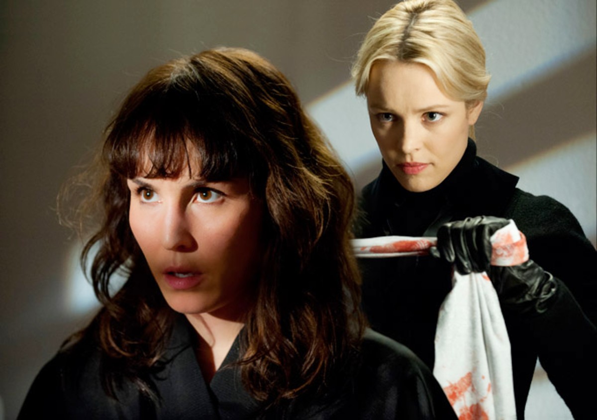 A woman stands behind another woman in 'Passion.'