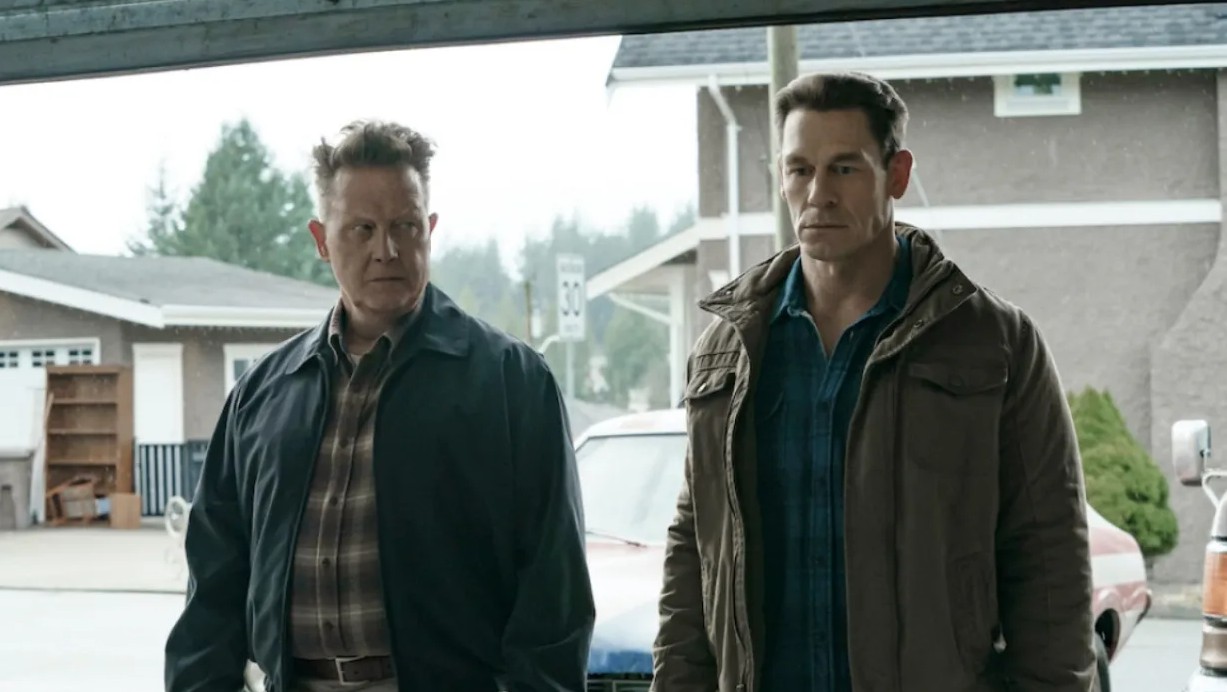 Two men stand side by side in 'Peacemaker.'