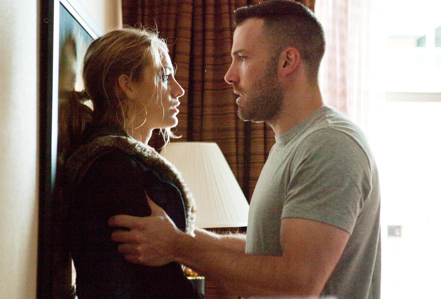 A man holds a woman in The Town.