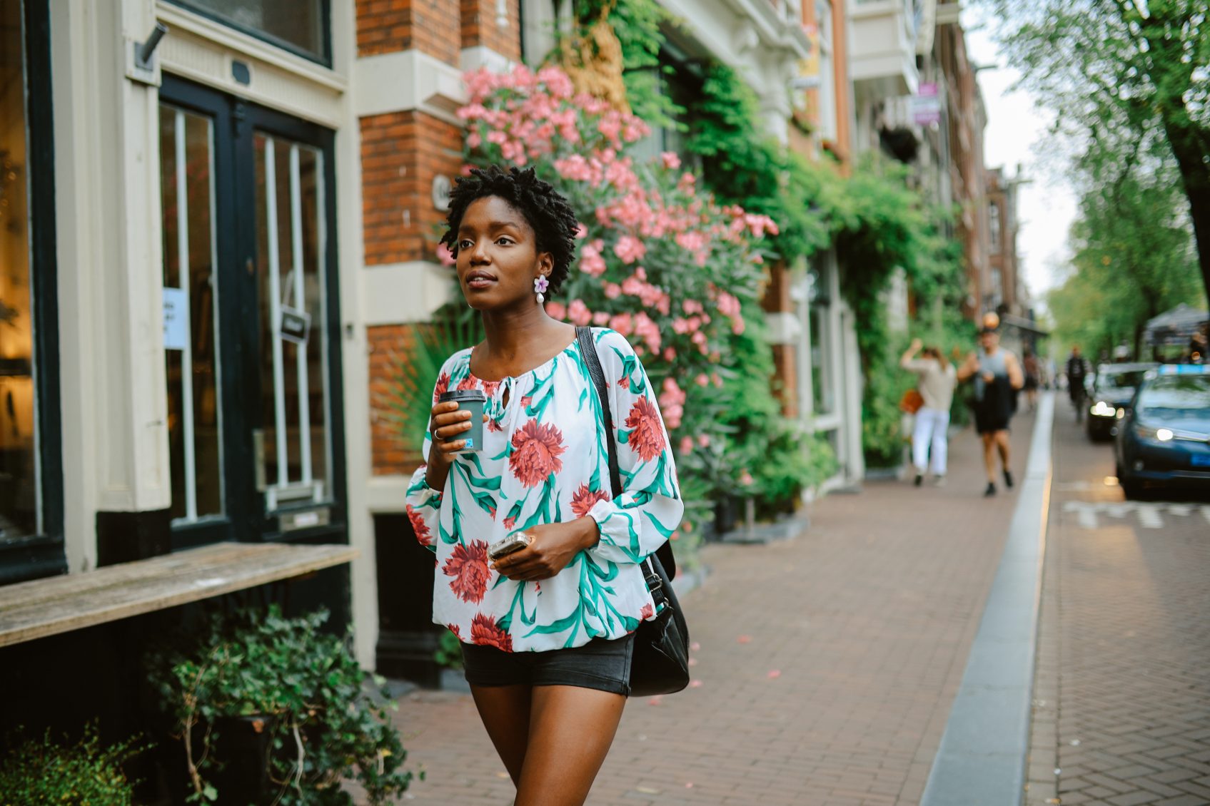 Amsterdam city lifestyle. Young woman walks the streets, casually exploring the city or going to meet her friends for a coffee. Travel and urban lifestyle concepts.