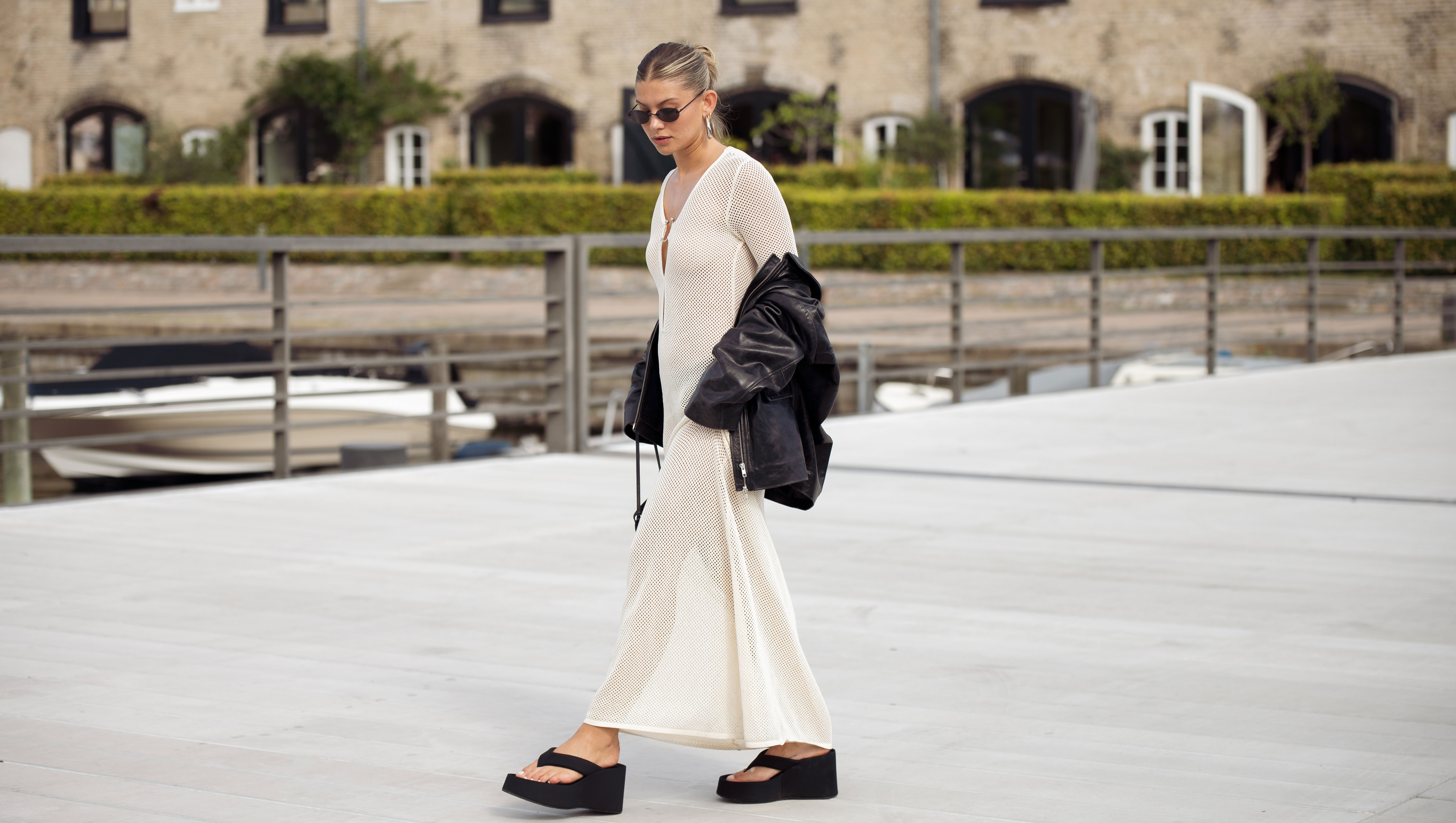 COPENHAGEN, DENMARK - AUGUST 08: Sophia Geiss wears a long beige knitted maxi dress, black flip flops, sandals, leather jacket and black bag during day four of the Copenhagen Fashion Week (CPHFW) SS25 on August 08, 2024 in Copenhagen, Denmark. (Photo by Raimonda Kulikauskiene/Getty Images)