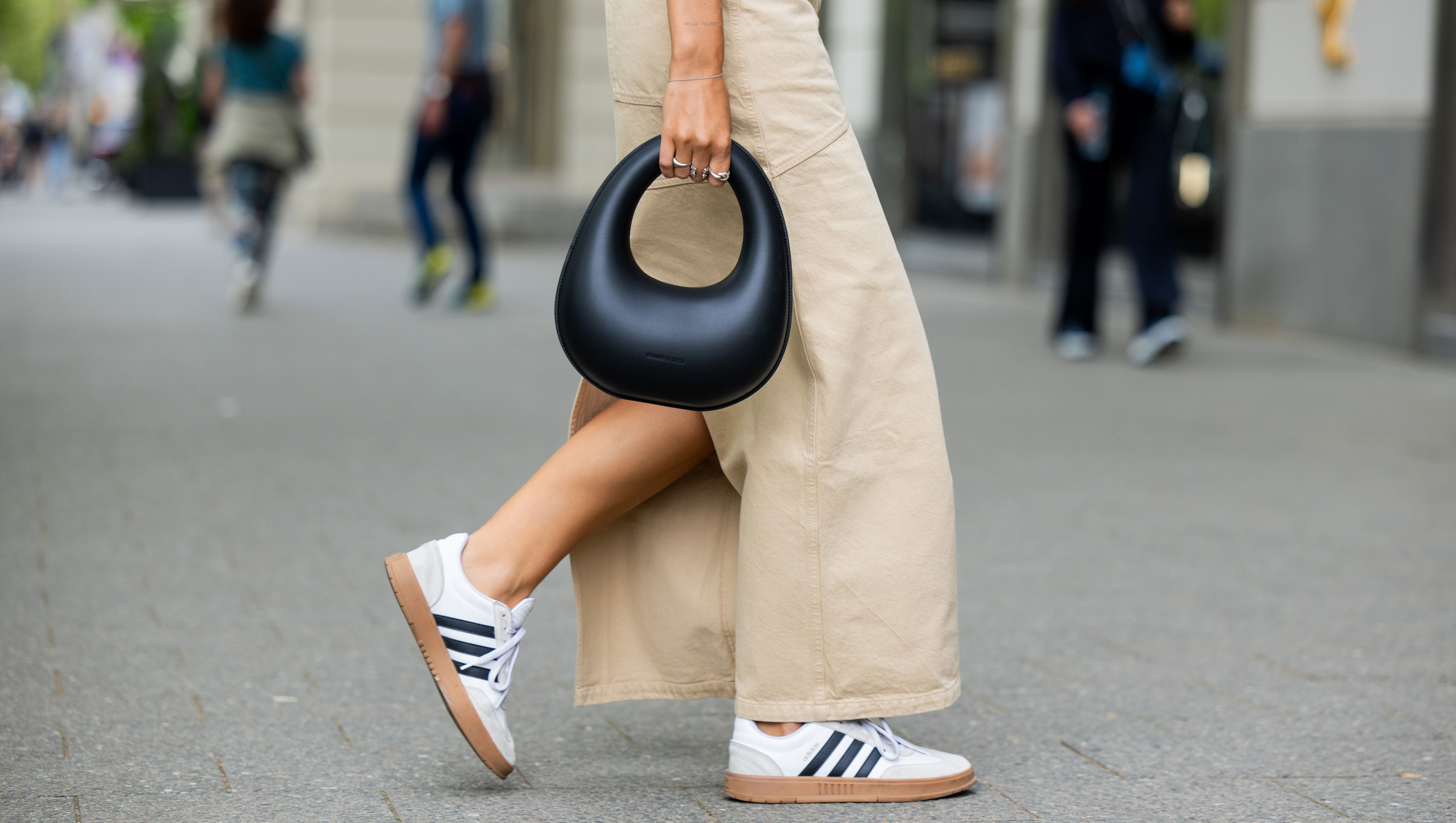 BERLIN, GERMANY - MAY 05: Jacqueline Zelwis wears sleevelss white 7forallmankind top, beige Herskind skirt, white Adidas sneakers, black Charles & Keith bag on May 05, 2024 in Berlin, Germany. (Photo by Christian Vierig/Getty Images)