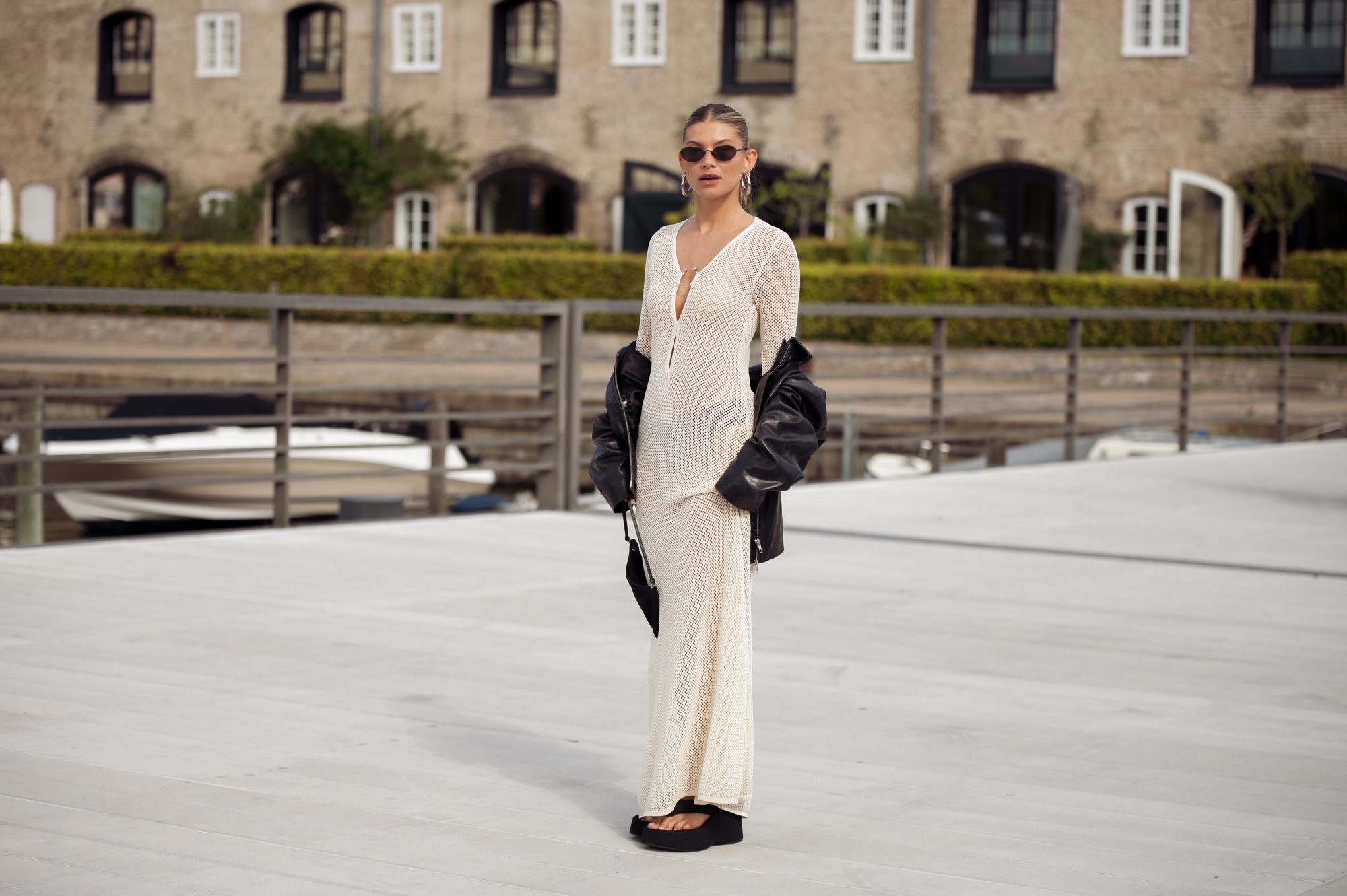 COPENHAGEN, DENMARK - AUGUST 08: Sophia Geiss wears a long beige knitted maxi dress, black flip flops, sandals, leather jacket and black bag during day four of the Copenhagen Fashion Week (CPHFW) SS25 on August 08, 2024 in Copenhagen, Denmark. (Photo by Raimonda Kulikauskiene/Getty Images)