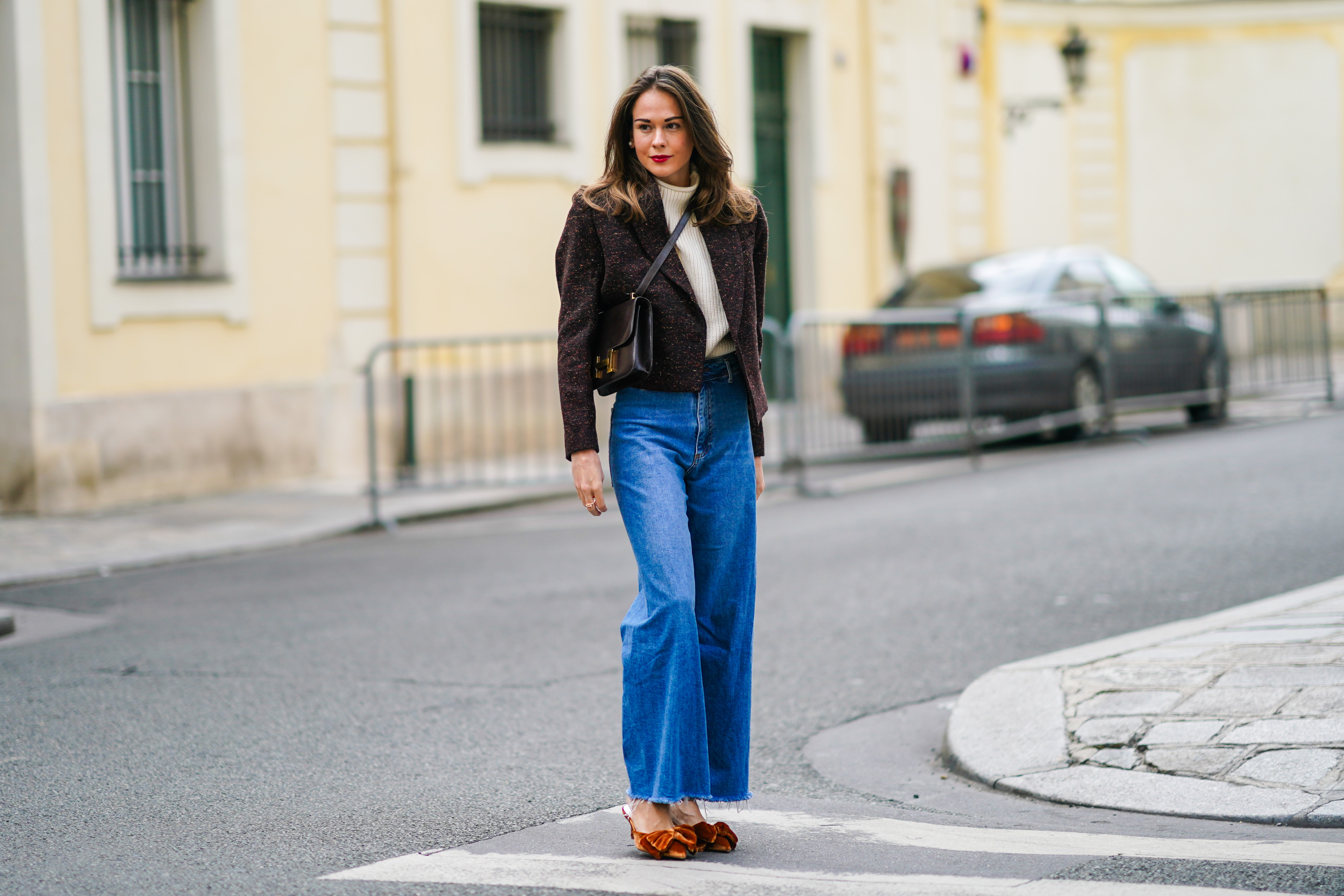 PARIS, FRANCE - OCTOBER 08: Therese Hellström wears a white wool turtleneck pullover, a brown blazer jacket with shoulder pads from Anine Bing, a Hermes leather bag, blue denim Custommade jeans, brown velvet pointy Custommade shoes with bow tie, on October 08, 2020 in Paris, France. (Photo by Edward Berthelot/Getty Images)