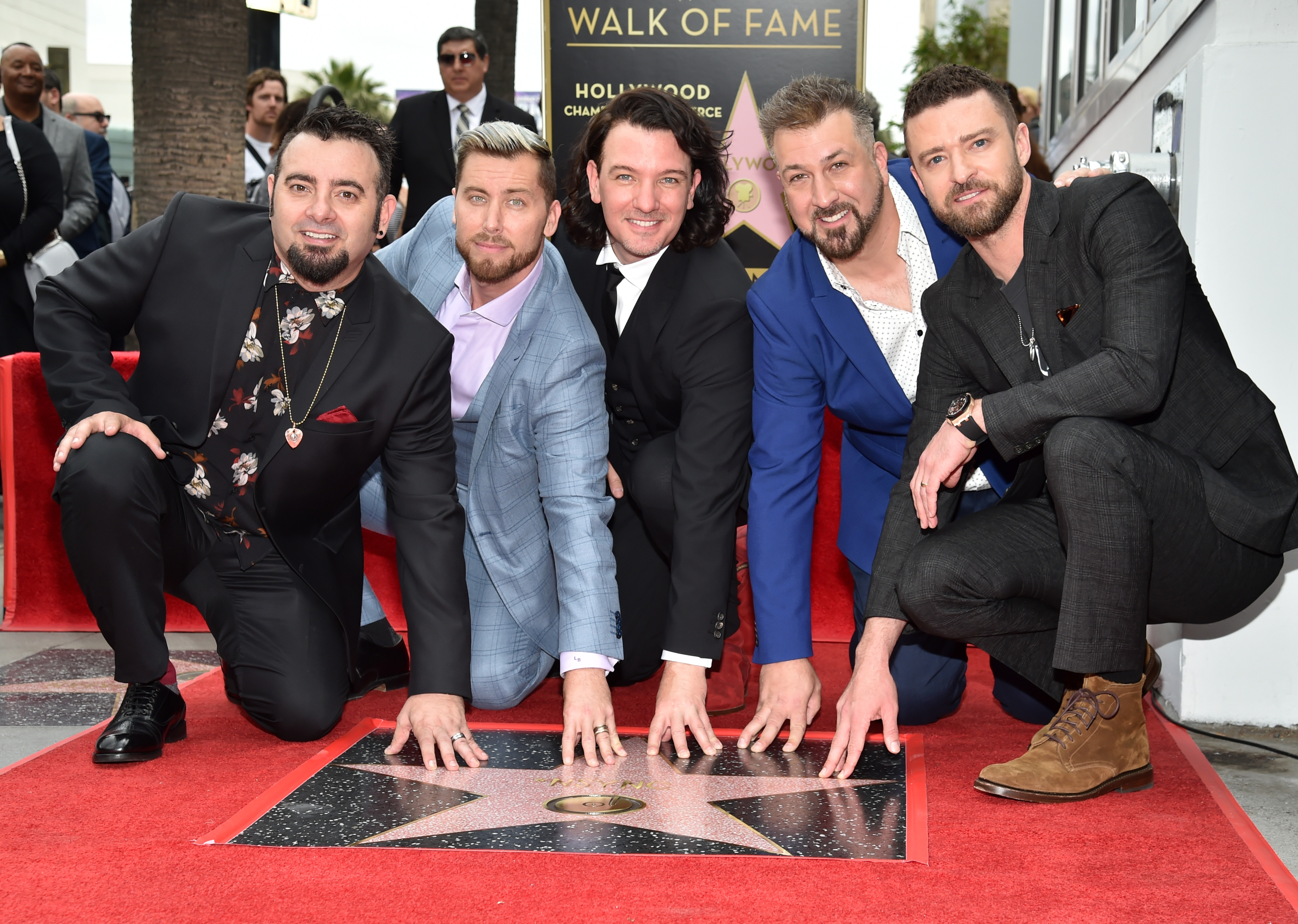 Chris Kirkpatrick, Lance Bass, JC Chasez, Joey Fatone and Justin Timberlake of 'NSync pose with their star on the Hollywood Walk of Fame.