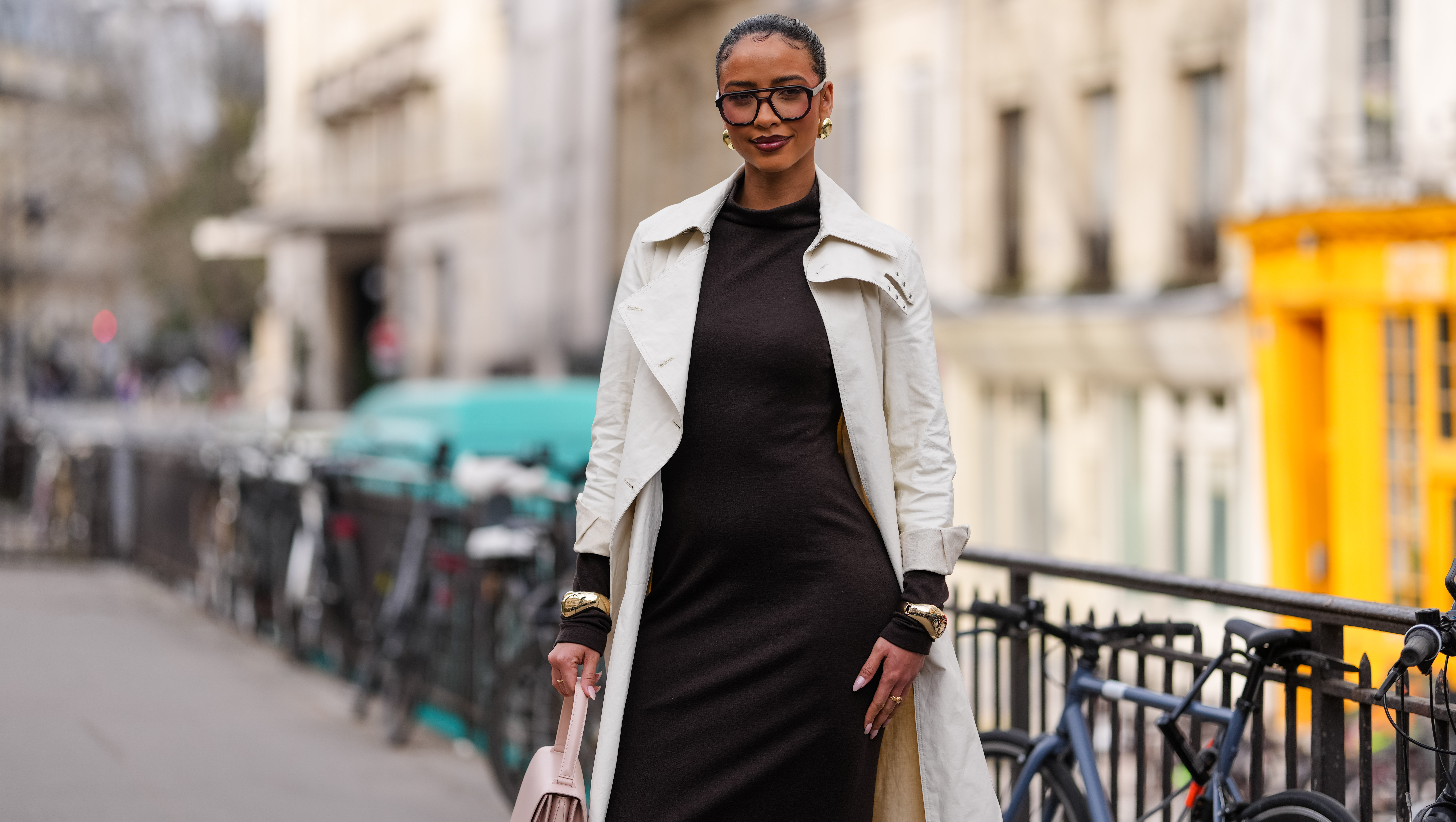 PARIS, FRANCE - MARCH 09: Flora Coquerel wears black sunglasses, gold earrings, dark brown high neck long sleeve midi dress, cream trench coat, gold bracelets, outside Akris, during the Paris Fashion week Women's Fall/Winter 2025-2026 on March 9, 2025 in Paris, France. (Photo by Edward Berthelot/Getty Images)