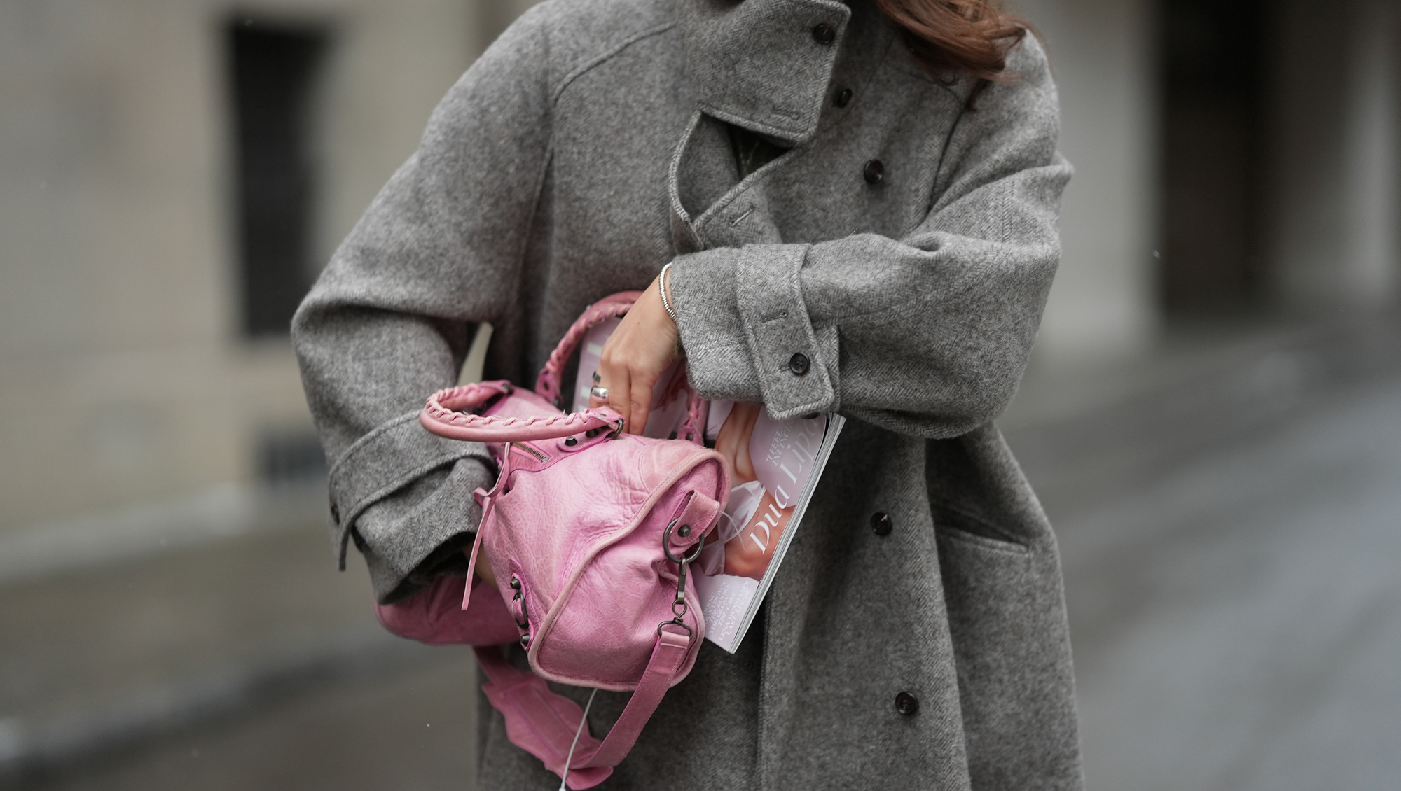 New Handbags MUNICH, GERMANY - JANUARY 8: Amanda Mühle is seen wearing a grey wool coat with wide lapels, button closure and buttoned collar from Siyazu; a pink leather Balenciaga “City bag” with a softly slouched shape, top handles and silver hardware from Balenciaga; multiple silver rings from Pilgrim; holding a Vogue Magazine on January 8, 2026 in Munich, Germany.