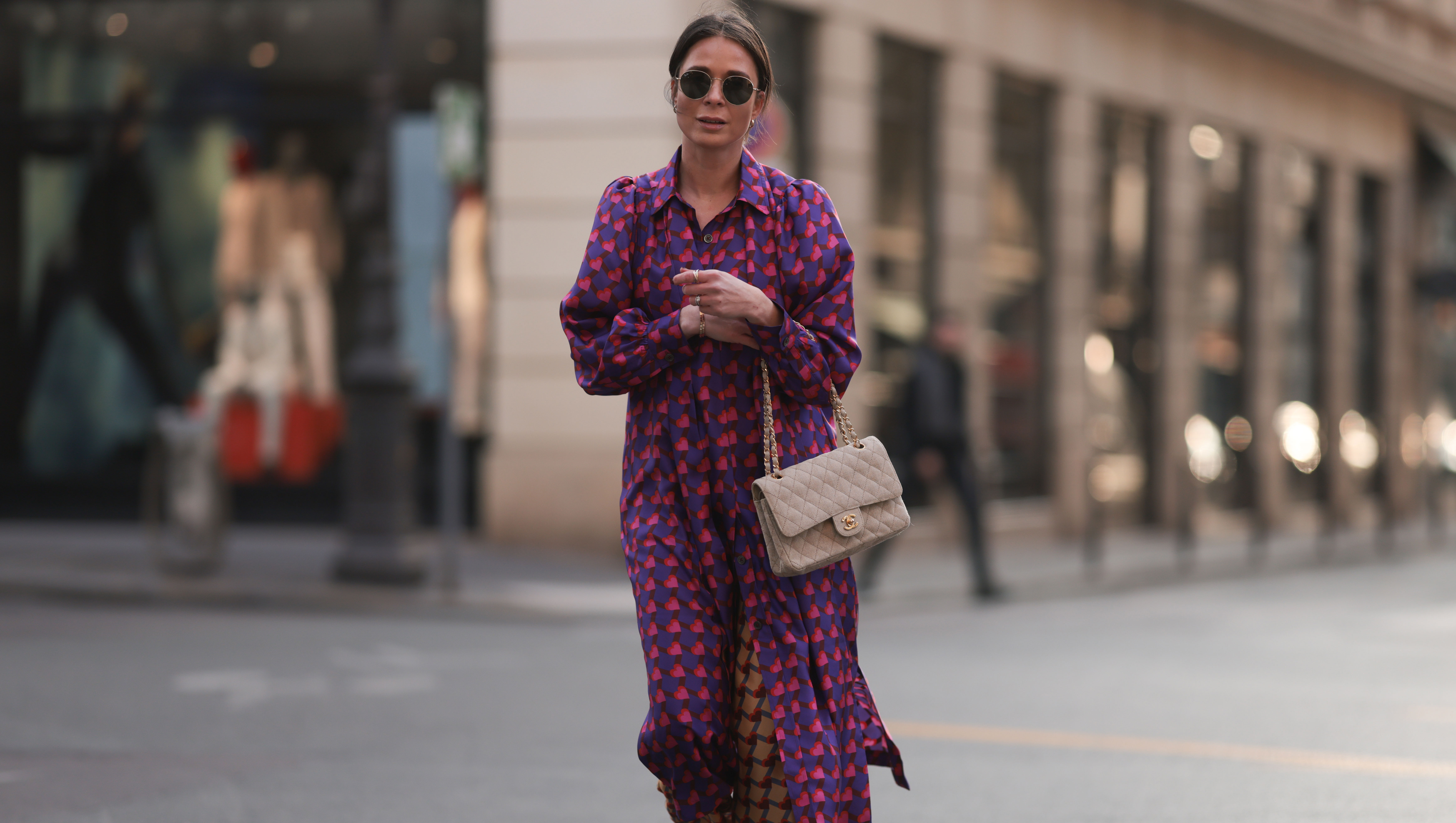 PARIS, FRANCE - MARCH 04: Patricia Wirschke seen wearing Ray-Ban gold round sunglasses, Odeeh purple / pink heart print pattern button maxi silk dress with long sleeves, Odeeh beige / red print pattern long silk pants, Chanel beige fabric flap bag, Chanel beige / black slingback leather heels / pumps, during Paris Fashion Week - Womenswear Fall Winter 2023 2024, on March 04, 2023 in Paris, France. (Photo by Jeremy Moeller/Getty Images)