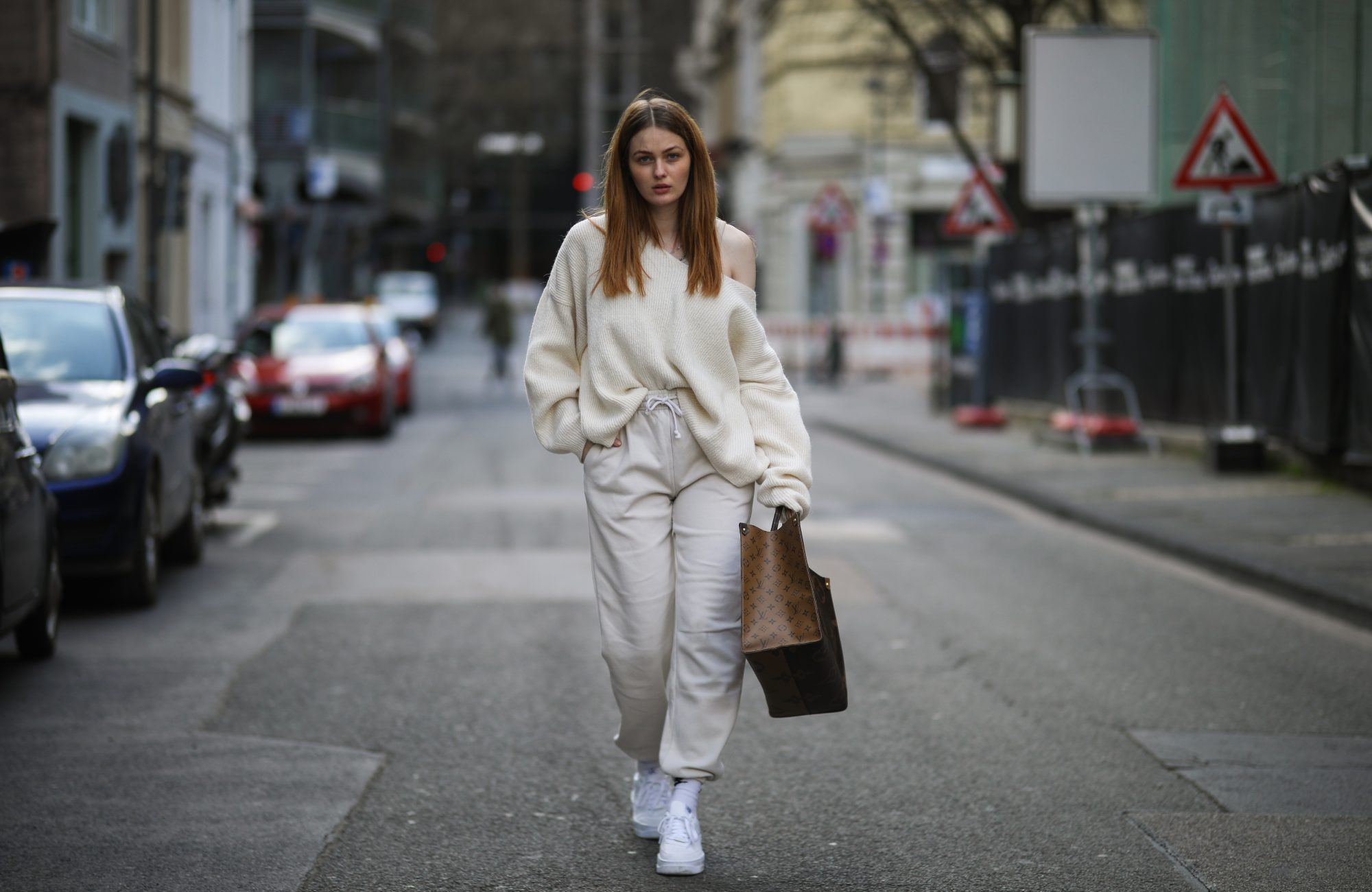COLOGNE, GERMANY - MARCH 26: Vanessa Stanat wearing beige Zara sweater, Louis Vuitton On The Go brown monogram travel bag, beige Nike sweatpants, white Nike socks and Nike Air Force sneakers on March 26, 2021 in Cologne, Germany. (Photo by Jeremy Moeller/Getty Images)