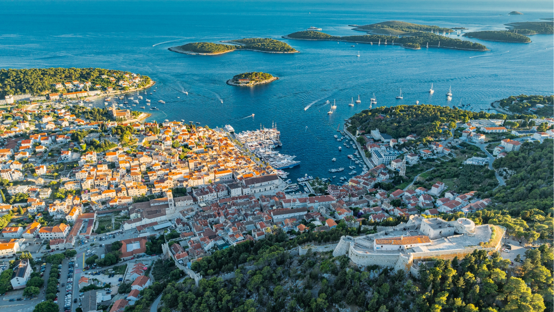 Scenic view of Hvar, Croatia, with turquoise Adriatic waters and historic architecture.