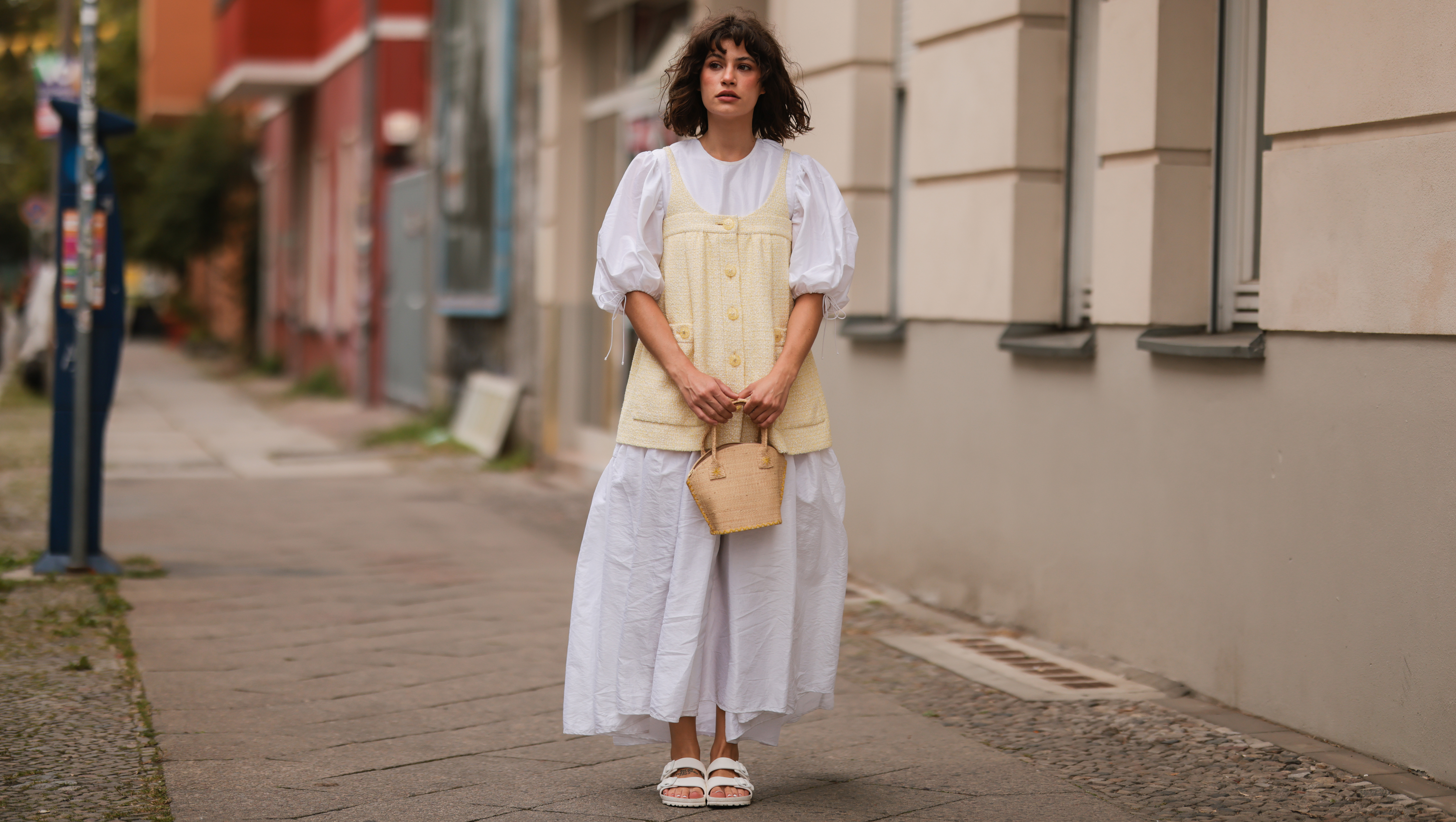 BERLIN, GERMANY - AUGUST 18: Lea Naumann wearing white Cecilie Bahnsen long dress, yellow Chanel vintage top, white Birkenstock sandals and Taillee mini bag on August 18, 2021 in Berlin, Germany. (Photo by Jeremy Moeller/Getty Images)