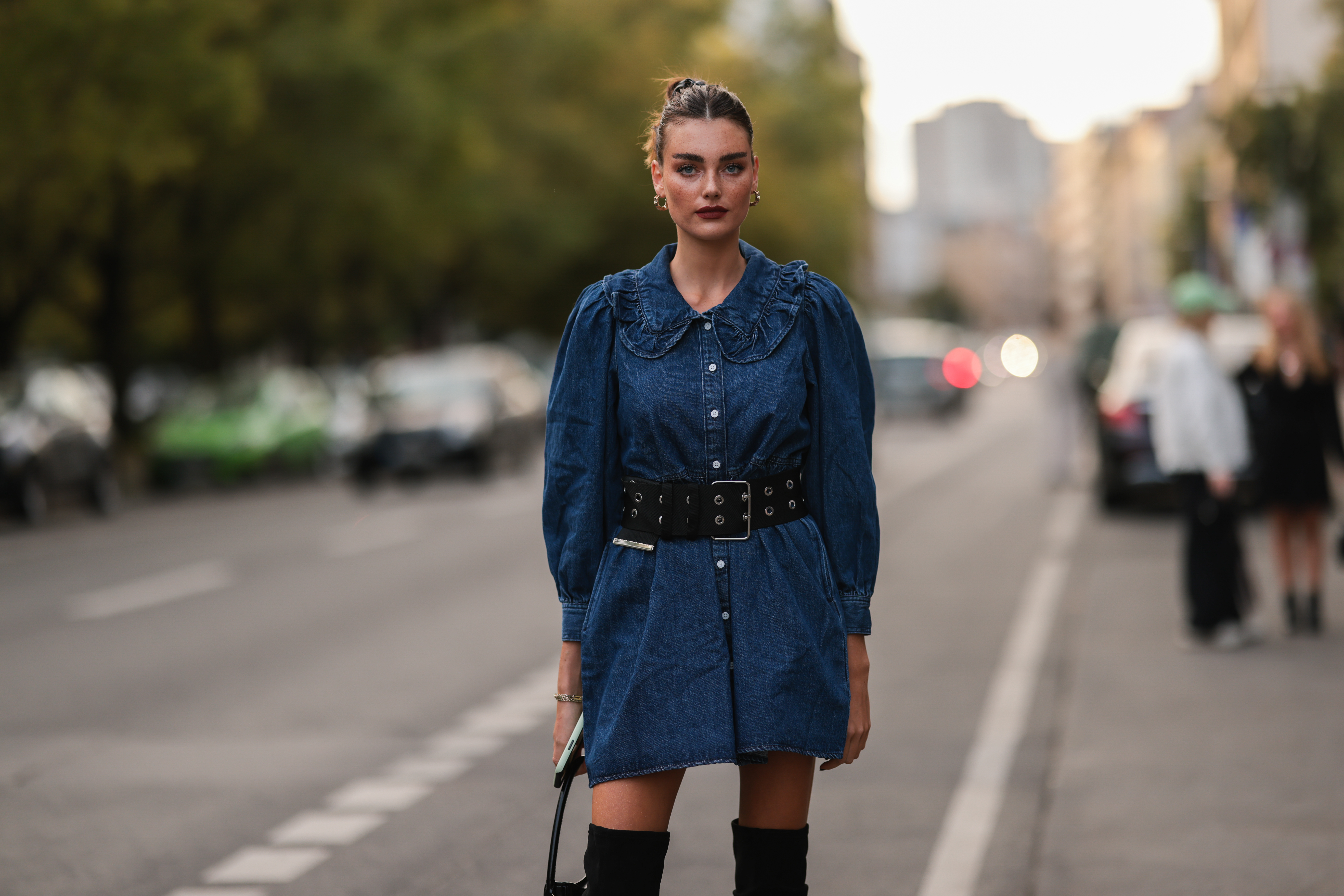 Celine Bethmann wearing a jeans dress, a black bag and black overknee boots on September 13, 2021 in Berlin, Germany.