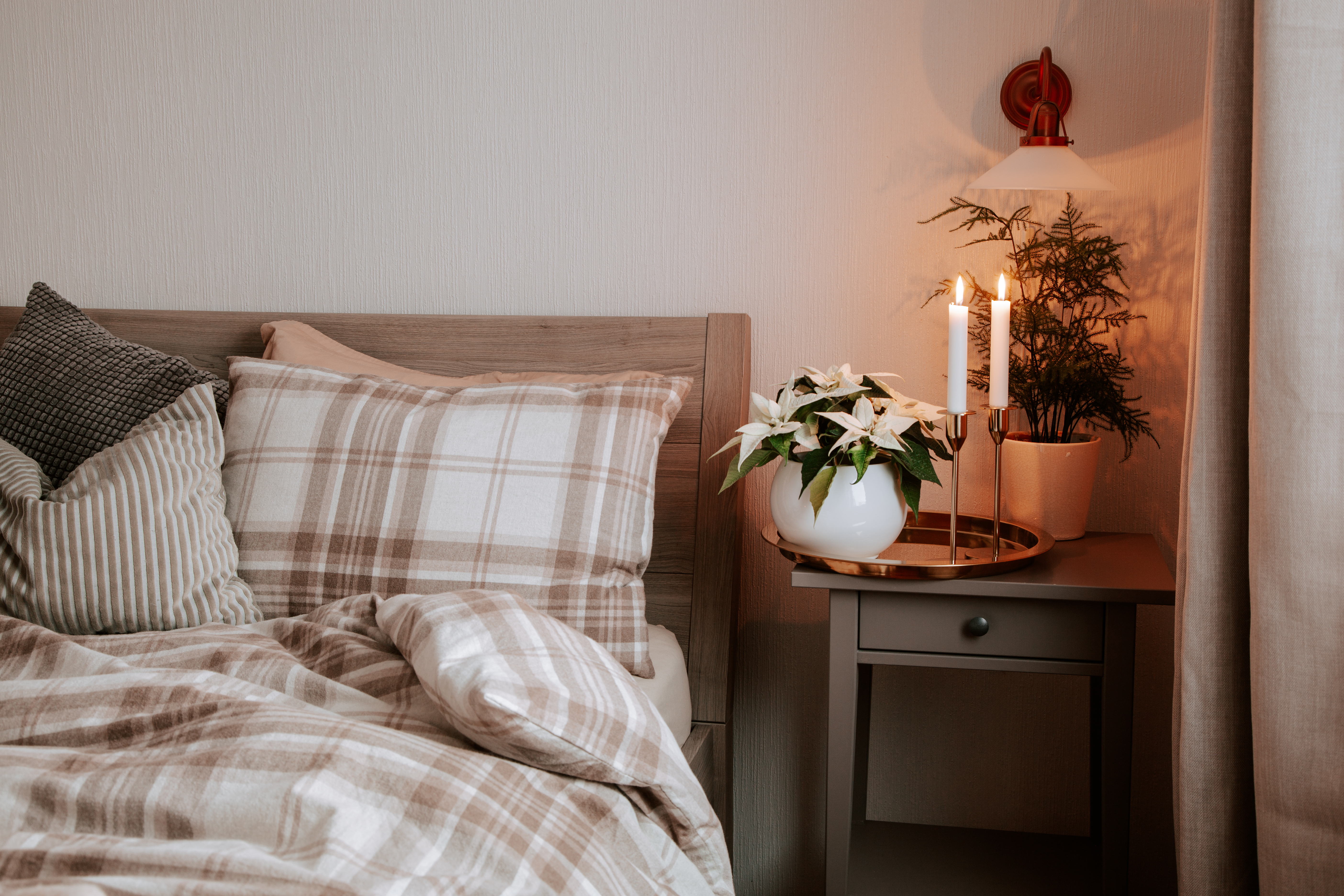 cozy scandinavian bedroom interior in natural tones, blanket candles houseplants