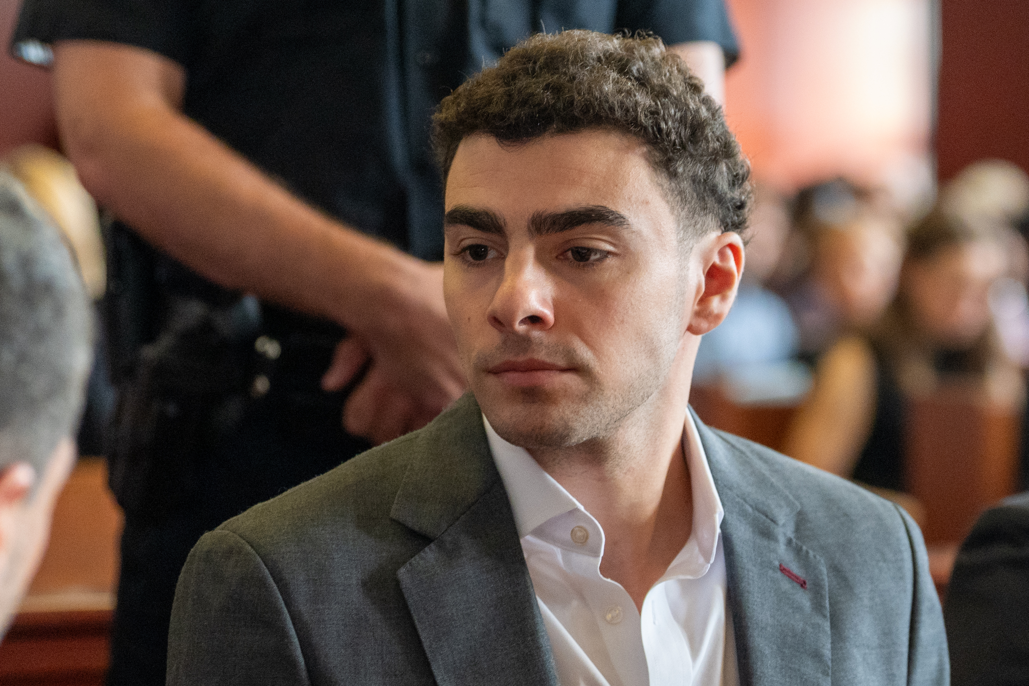Luigi Mangione sitting in court.