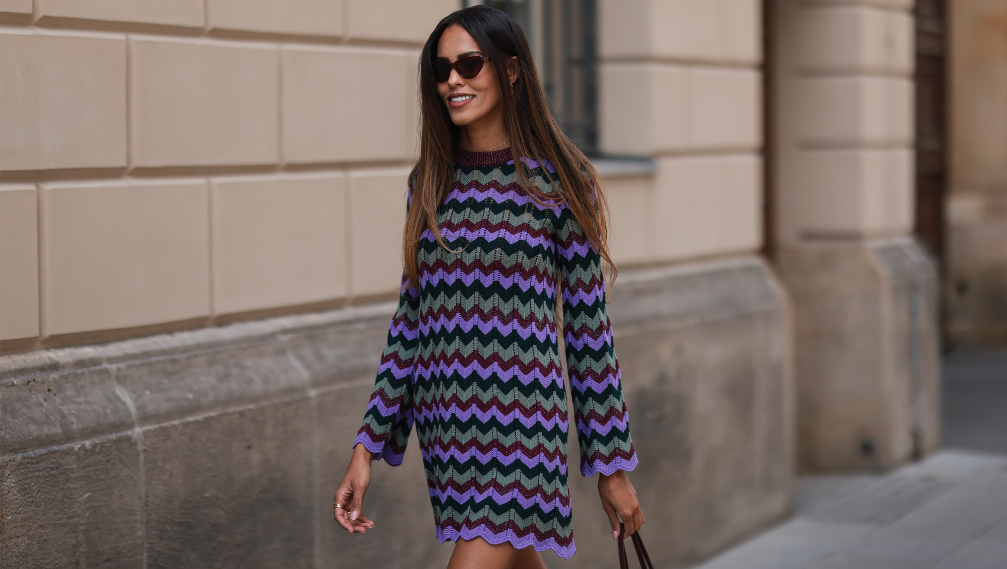Jill Asemota is seen wearing a purple, blue and green midi Missoni dress, a brown Hermes Constance leather bag and black Fendi sunnies on July 28, 2022 in Berlin, Germany.