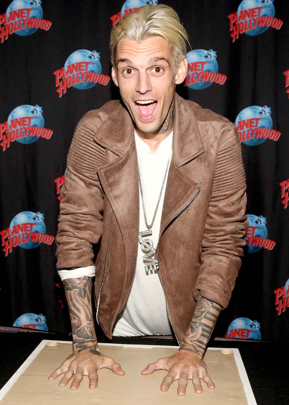 Aaron Carter poses during a handprint ceremony and meet & greet with fans as he visits Planet Hollywood Times Square on April 24, 2017 in New York City.