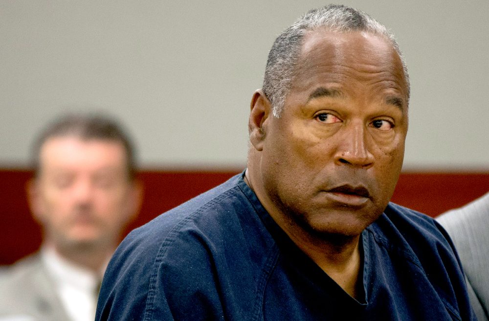 O.J. Simpson listens as his defense attorney, Ozzie Fumo, questions witness David Cook during an evidentiary hearing in Clark County District Court May 16, 2013 in Las Vegas, Nevada.