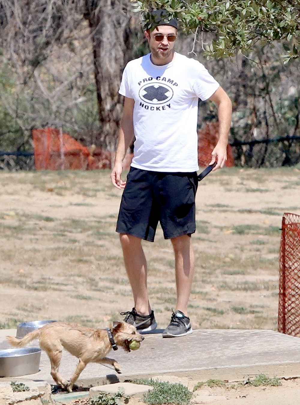 Robert Pattinson enjoys a day at the dog park with his pooch on July 15, 2017.